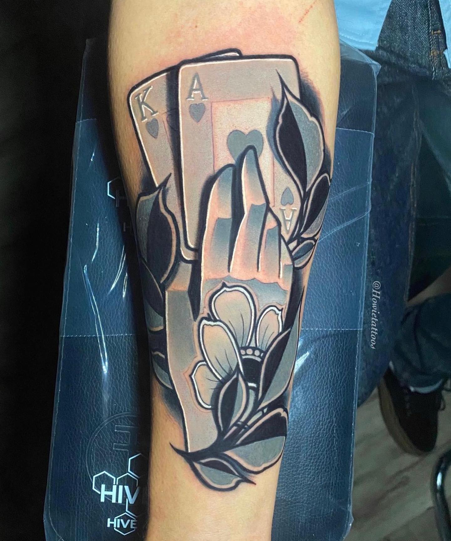 Playing cards and hand American traditional tattoo on the forearm by Brian Horowitz