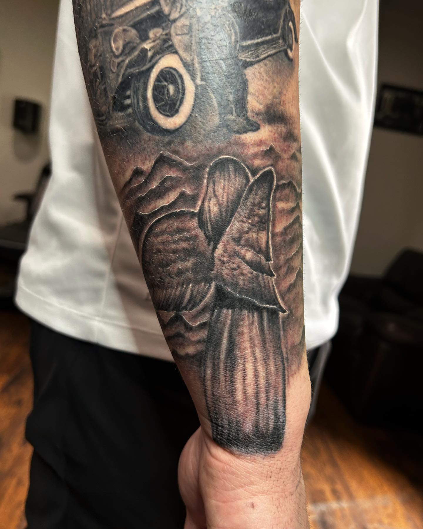 Automobile and butterfly realism tattoo on the forearm by Visionary Tattoos
