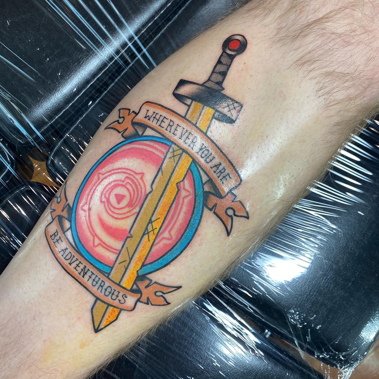Sword and shield new school tattoo on the forearm by S C O T T