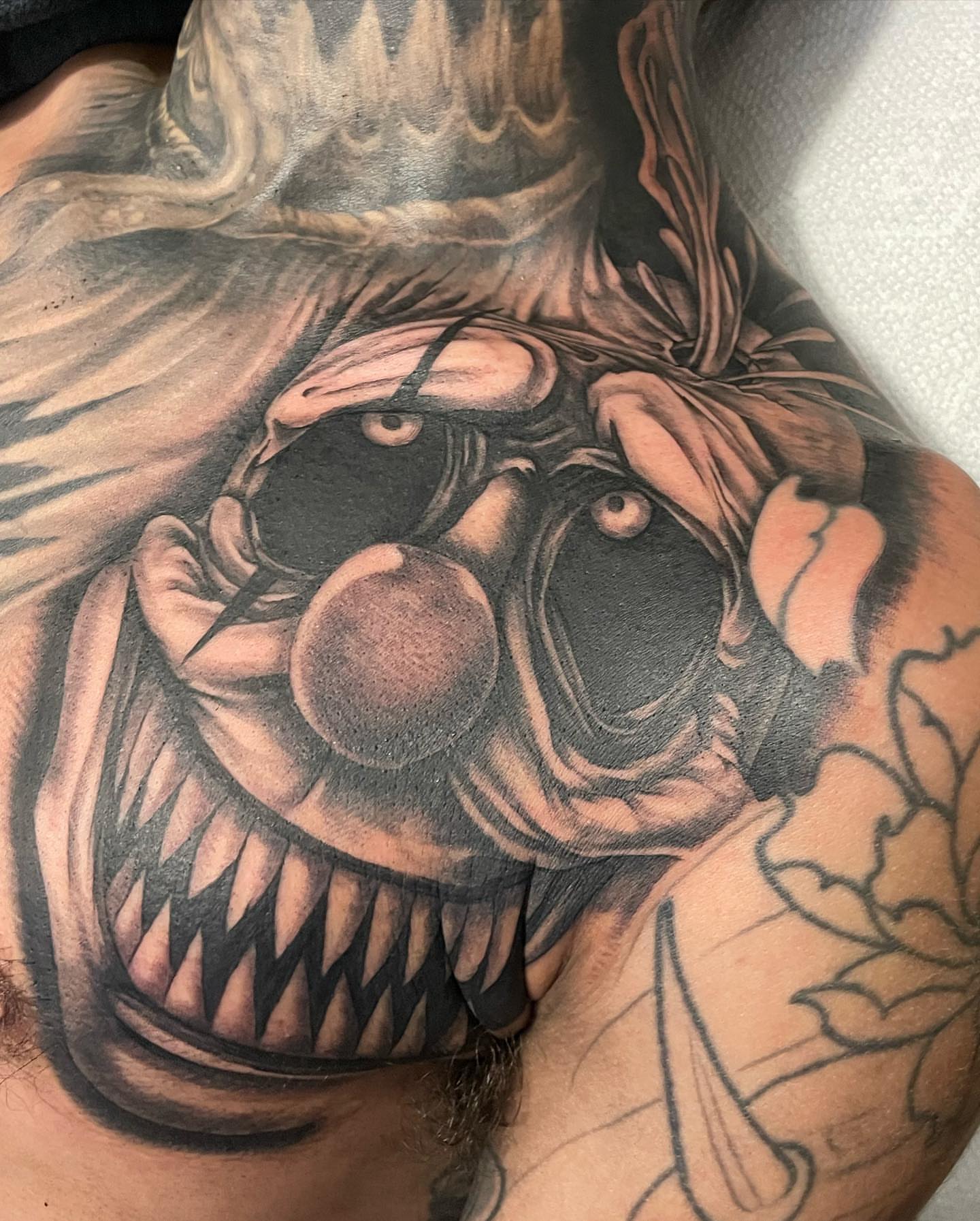 Clown black and grey tattoo on the chest by payaso