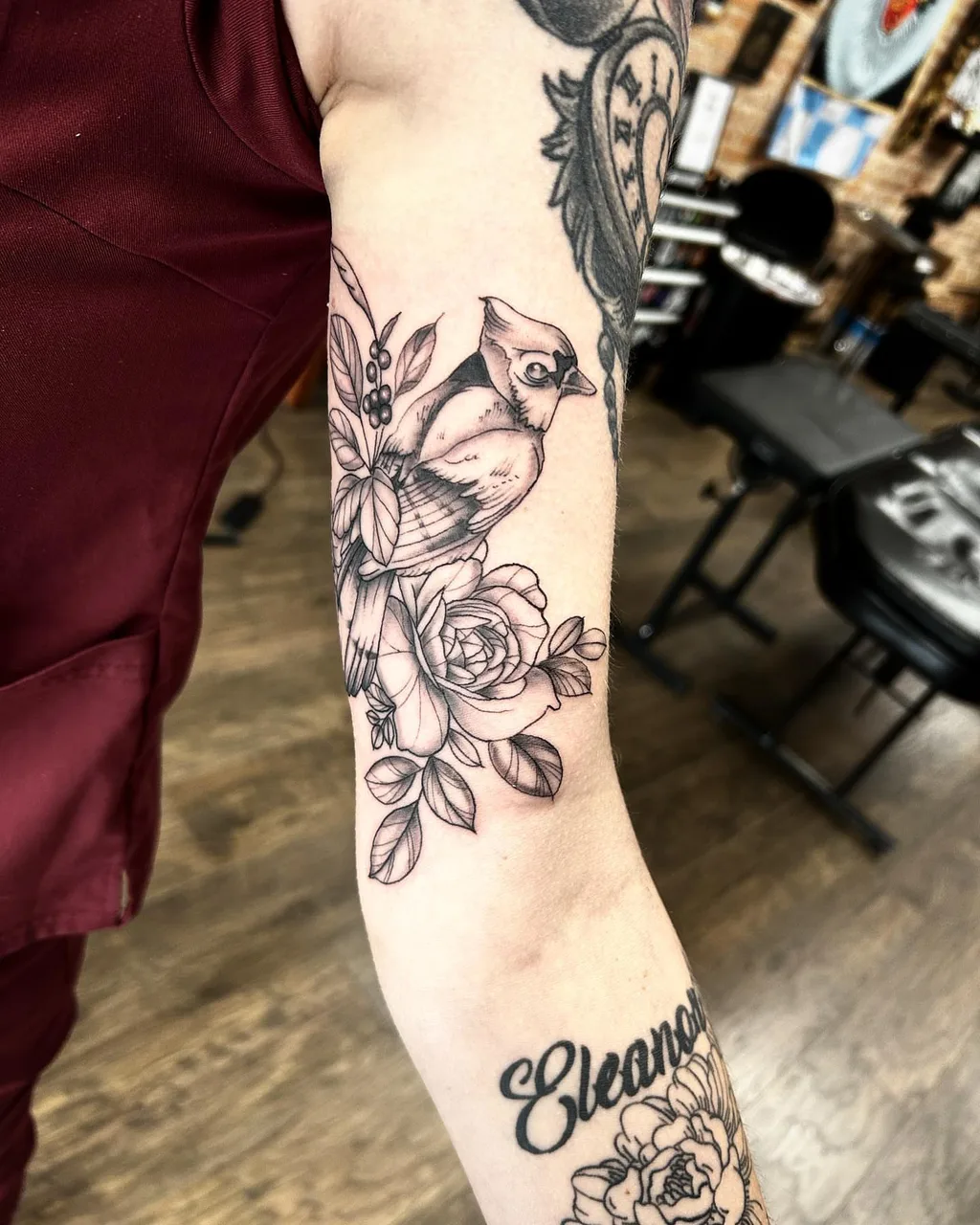 Bird and roses black and grey tattoo on the forearm by Dylan Stevens