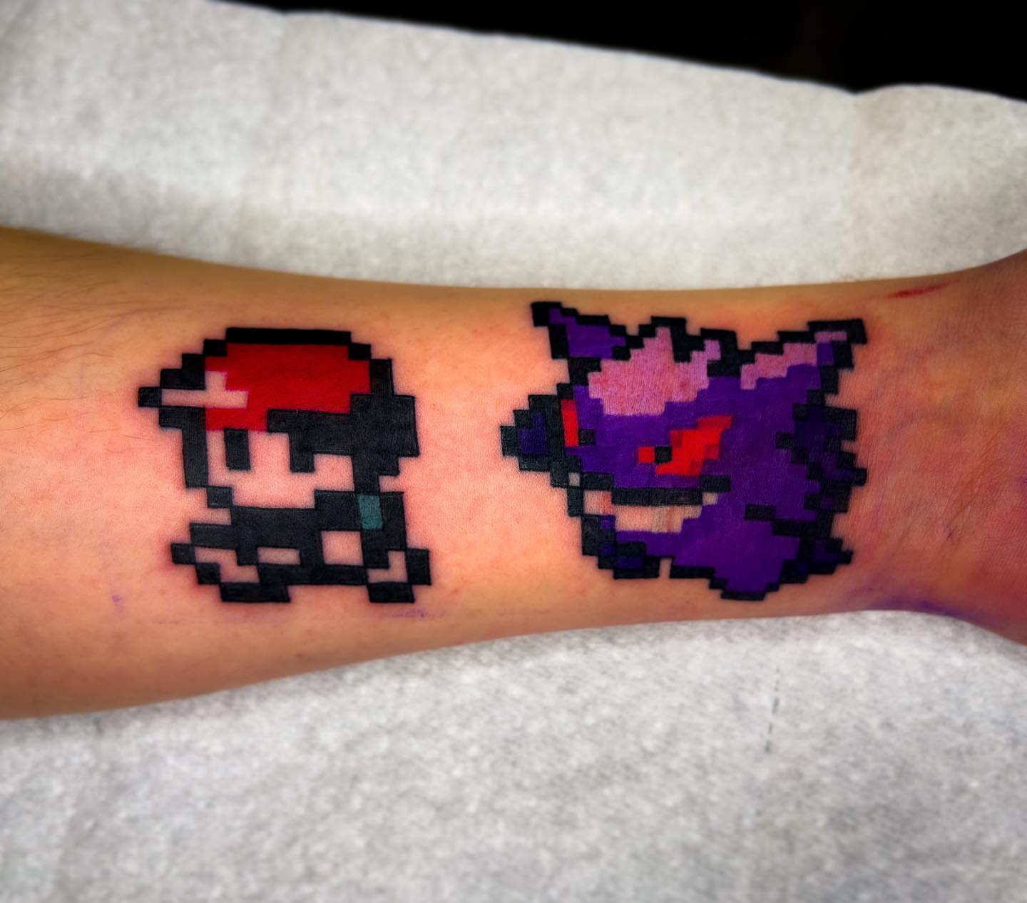 Pixel art tattoo on the forearm by Neeko