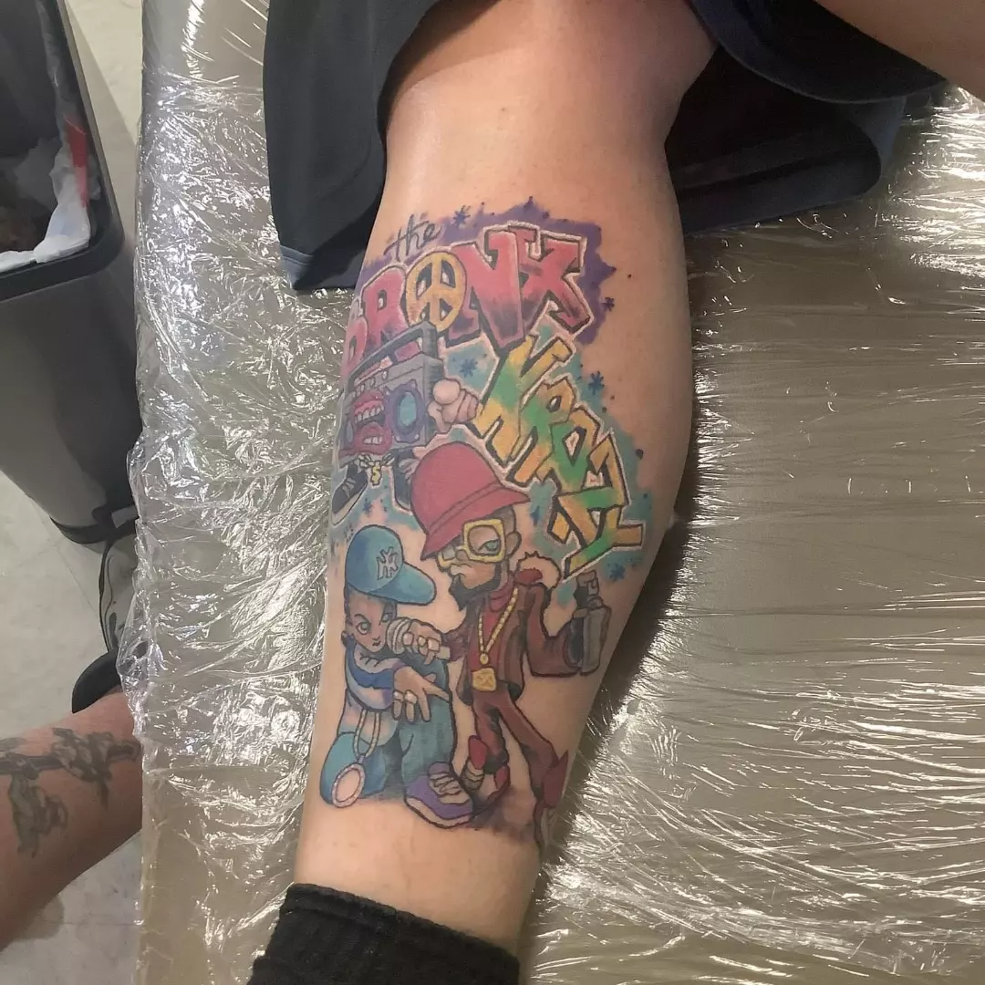 New school tattoo on the forearm by Russell Lucas