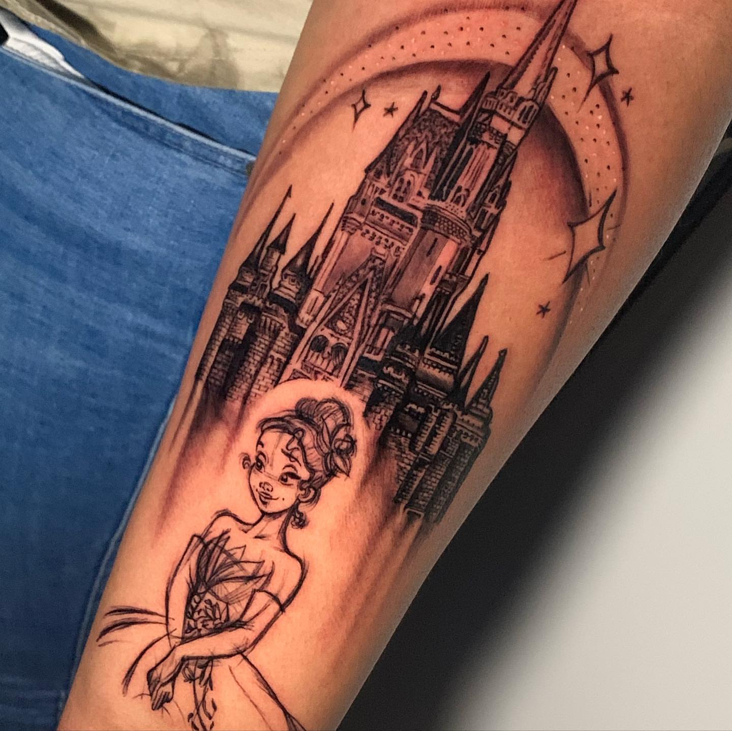 Tiana and castle black and grey tattoo on the forearm by james padelt