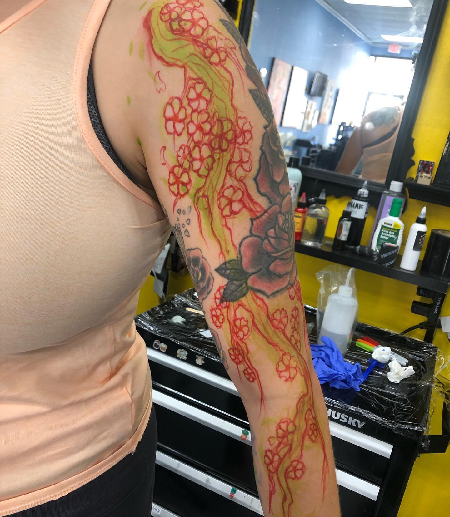 Cherry blossoms and rose japanese irezumi tattoo on the upper arm by Saint Jimmy
