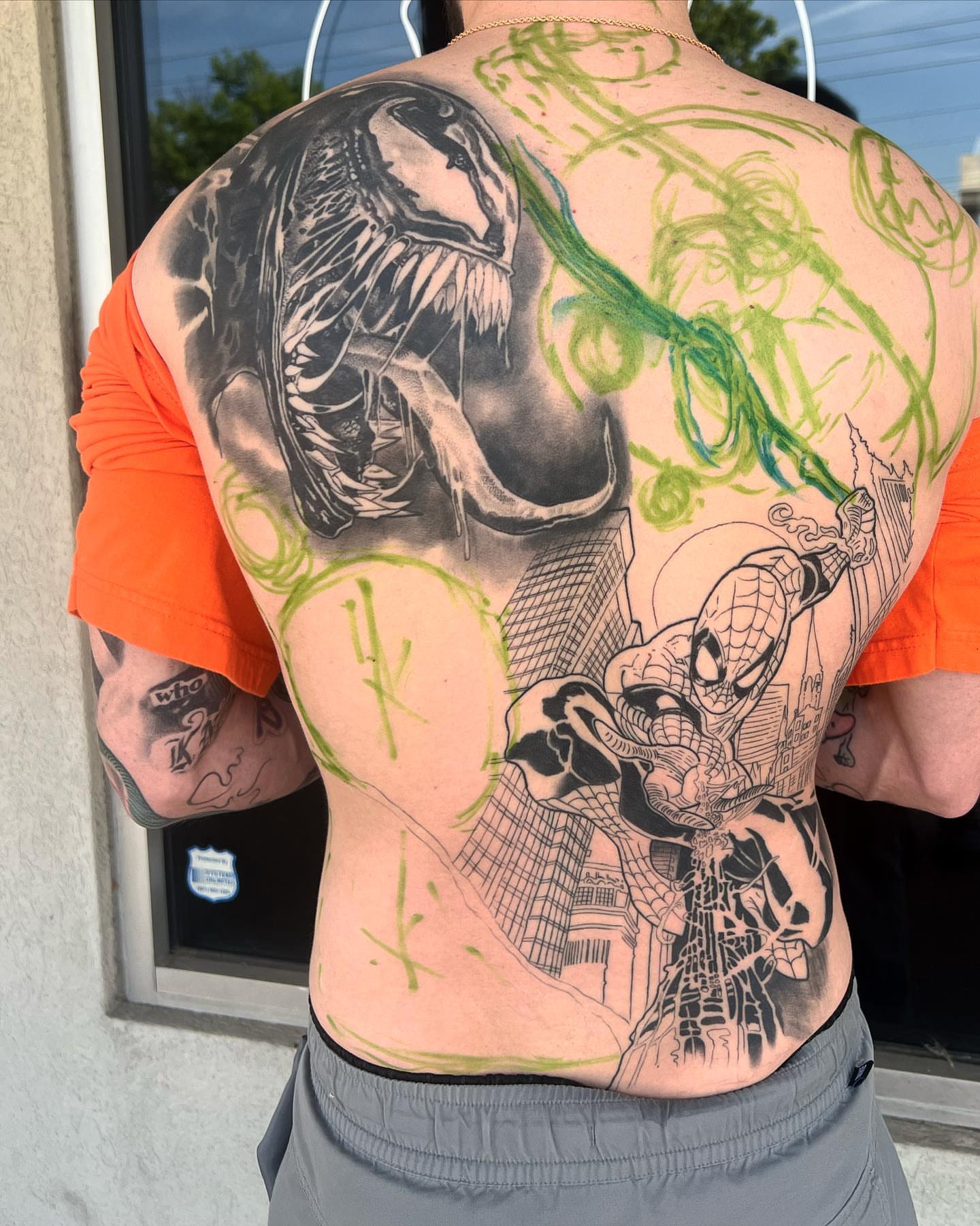 Venom and Spider-Man realism tattoo on the back by Briana Walker