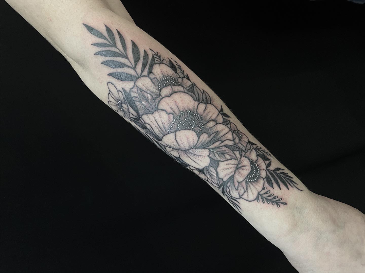 Floral bouquet black and grey tattoo on the forearm by Ksu Storm, San Francisco, California