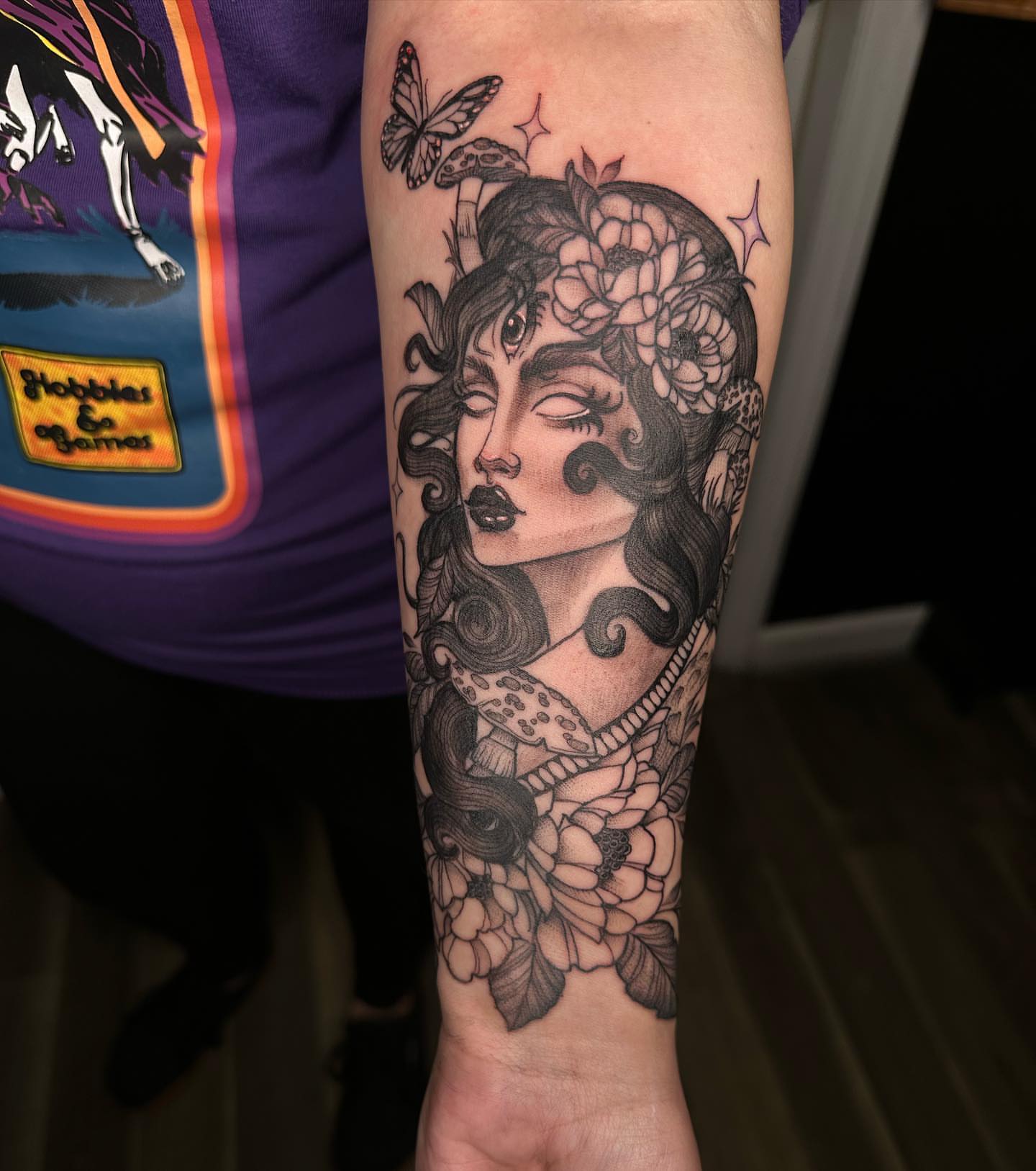 Woman with flowers realism tattoo on the forearm by 𝕵𝖊𝖘𝖘𝖆 𝕭𝖎𝖌𝖊𝖑𝖔𝖜, Harrison, New Jersey