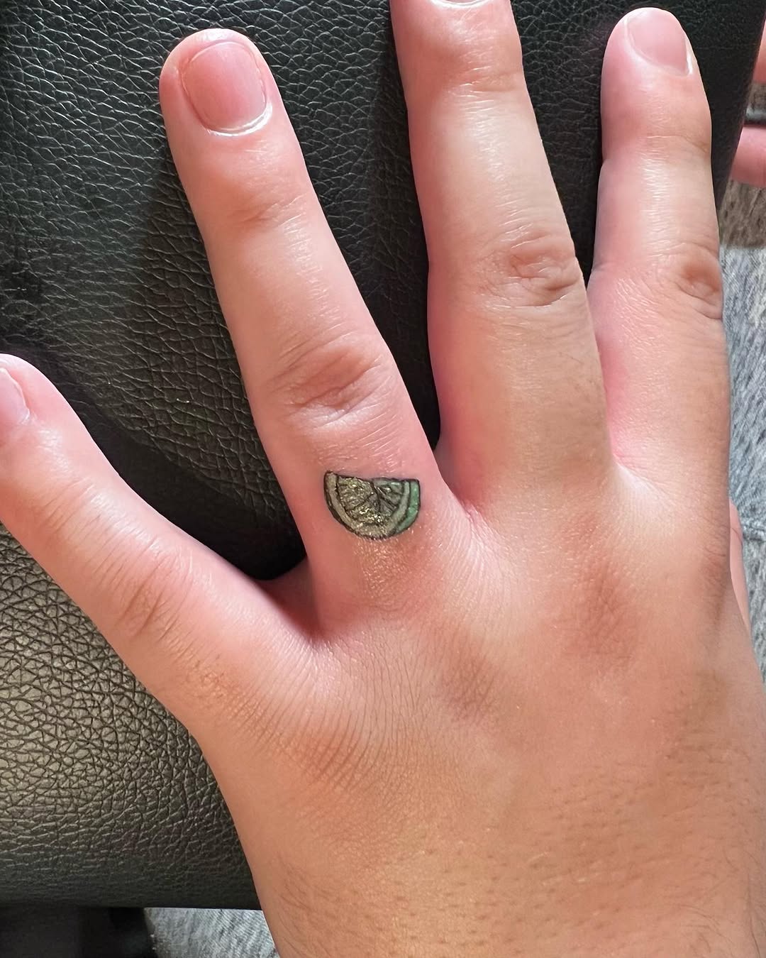 Lime slice tattoo on the hand by Lea-yae’