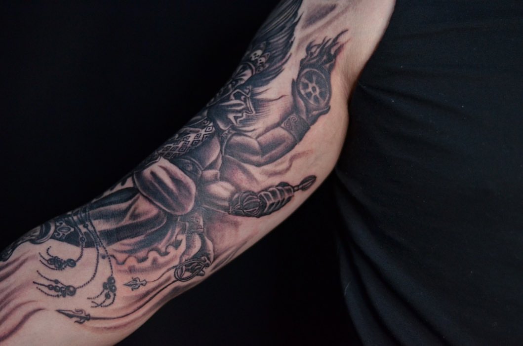 Muscular figure black and grey tattoo on the forearm by Ksu Storm, San Francisco, California