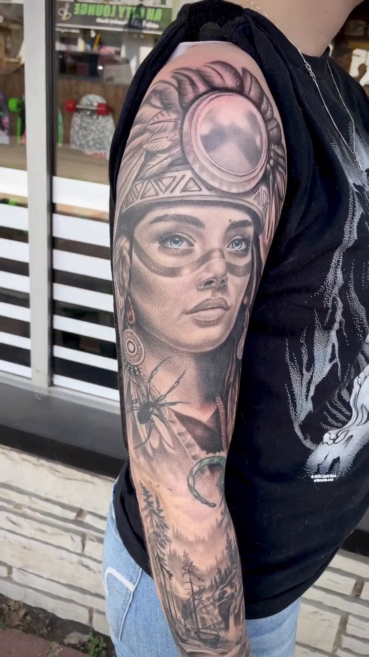Woman with headdress and wolf realism tattoo by Charlie
