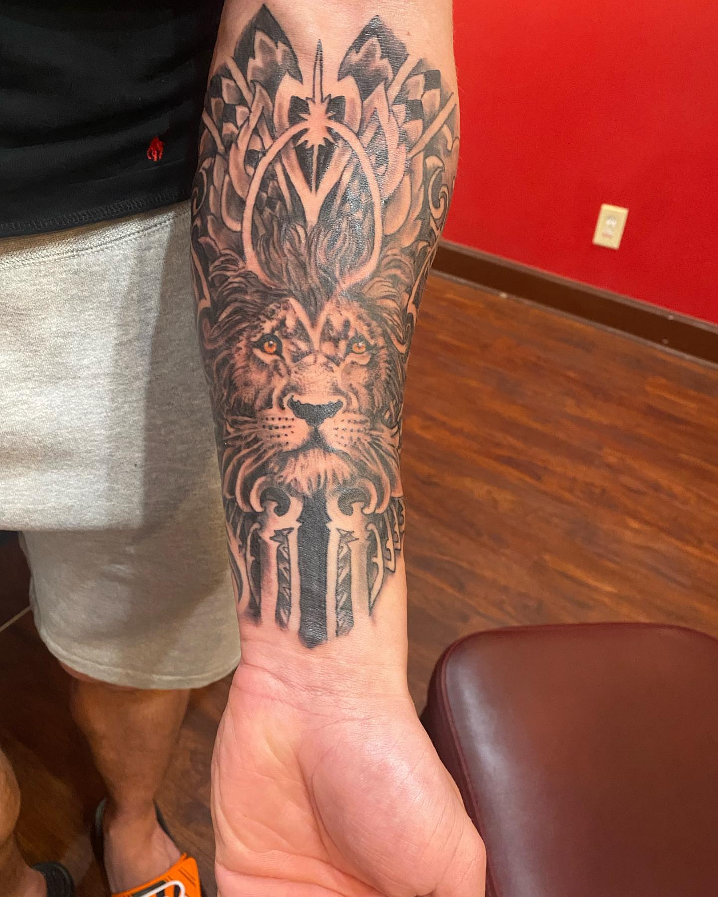 Lion realism tattoo on the forearm by Christopher Sanders