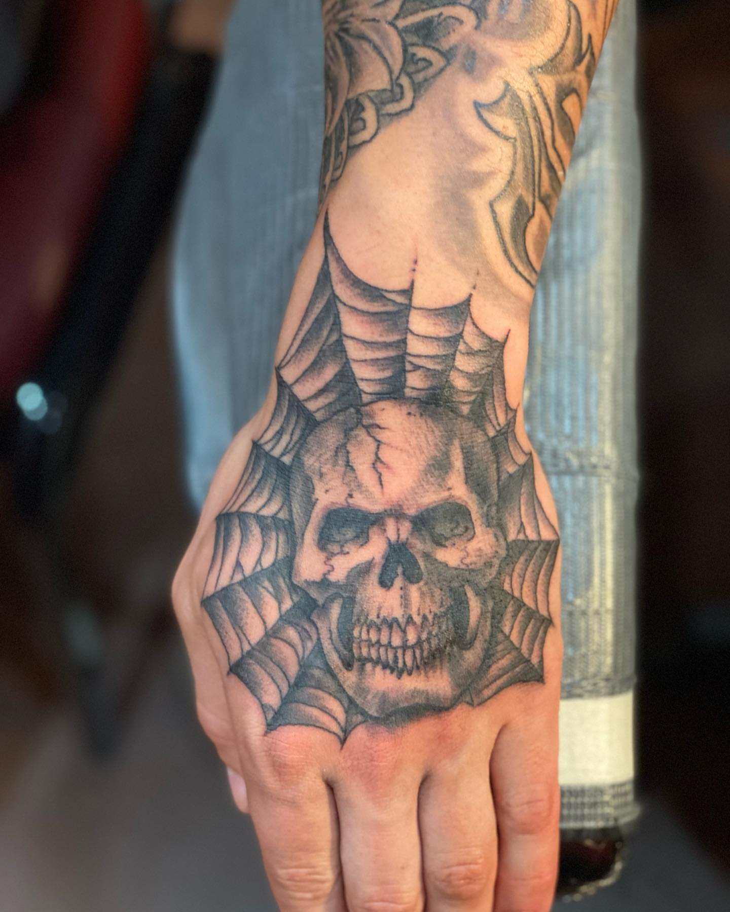 Skull realism tattoo on the hand by Christopher Sanders