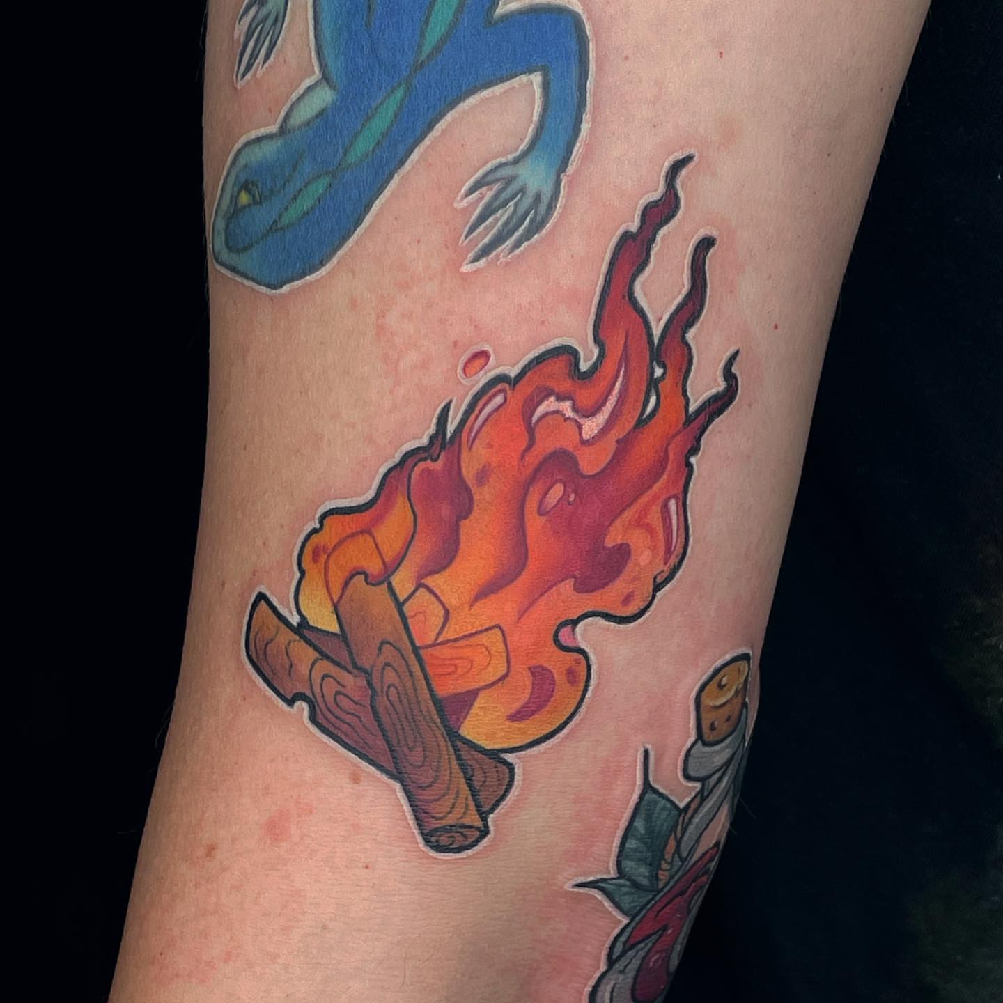 Fire and wood American traditional tattoo on the forearm by Ksu Storm, San Francisco, California