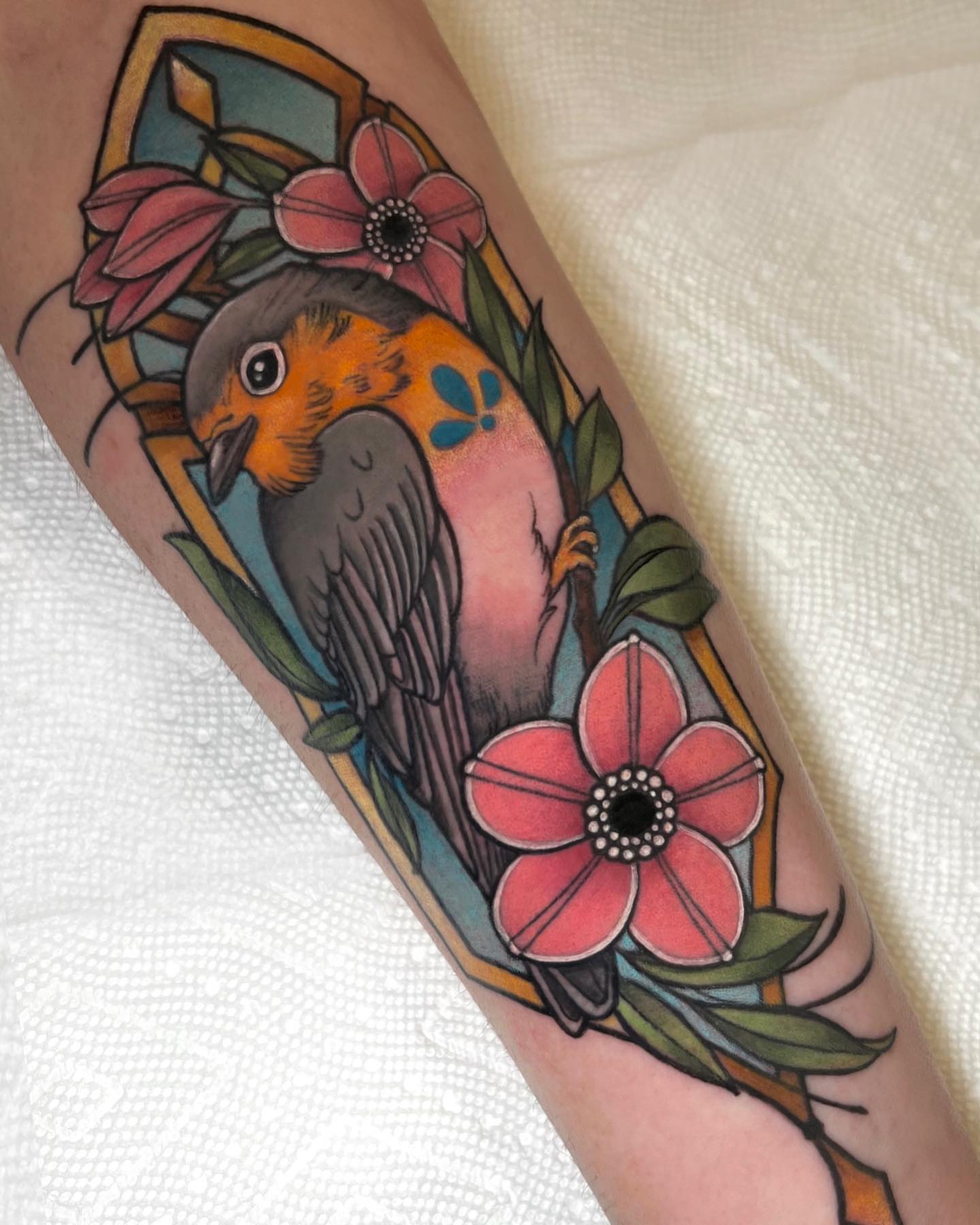 Bird and flowers American traditional tattoo on the forearm by Cortney Norton