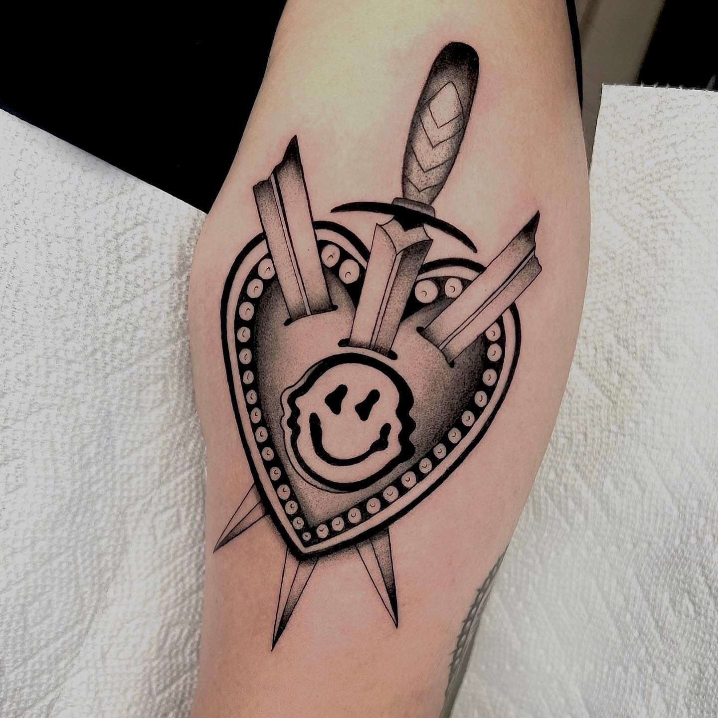Smiley face dotwork tattoo on the forearm by 🤎Dannon 🕸