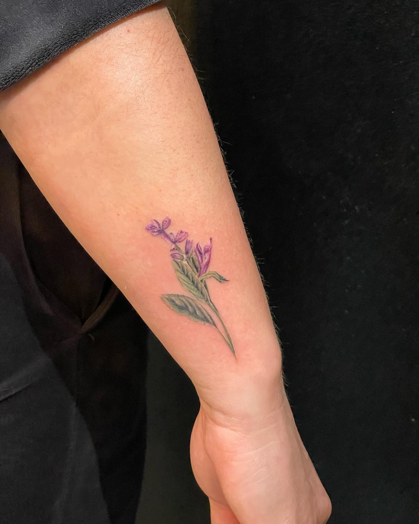 Purple flower realism tattoo on the forearm by Ksu Storm, San Francisco, California