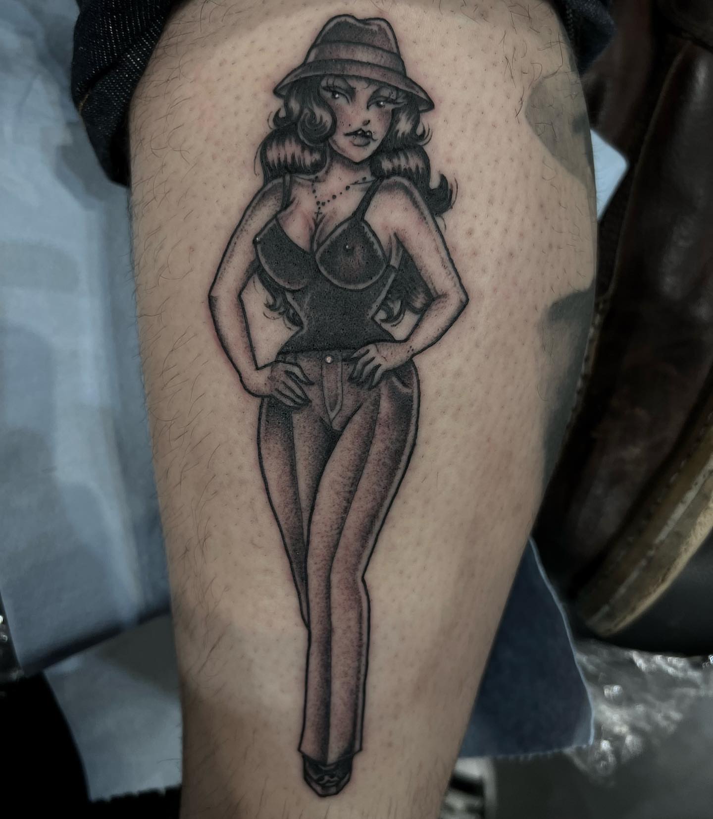 Pin-up girl American traditional tattoo on the thigh by Valerie Dominguez