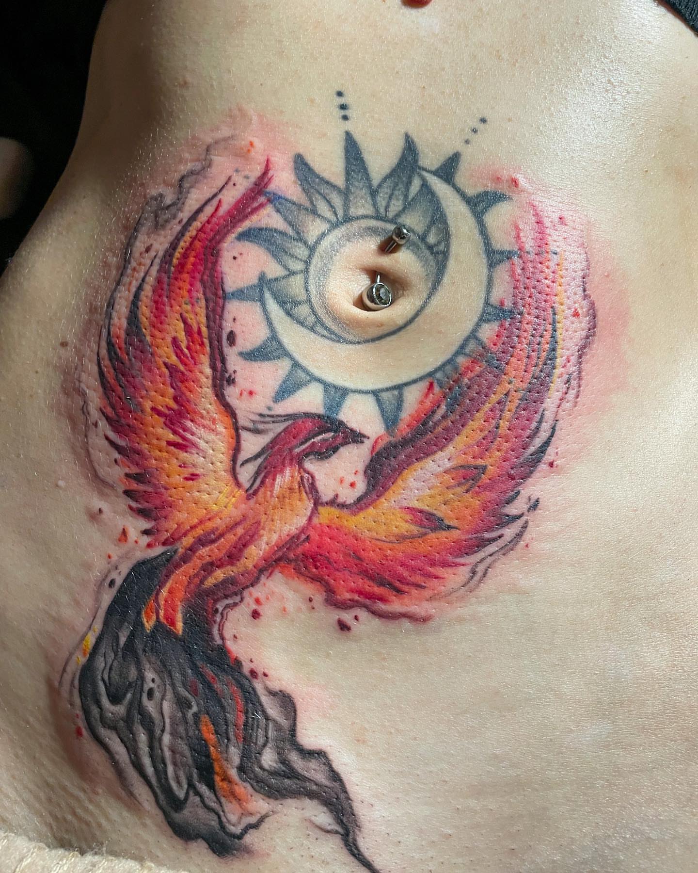 Phoenix and sun dotwork tattoo on the chest by Ksu Storm, San Francisco, California