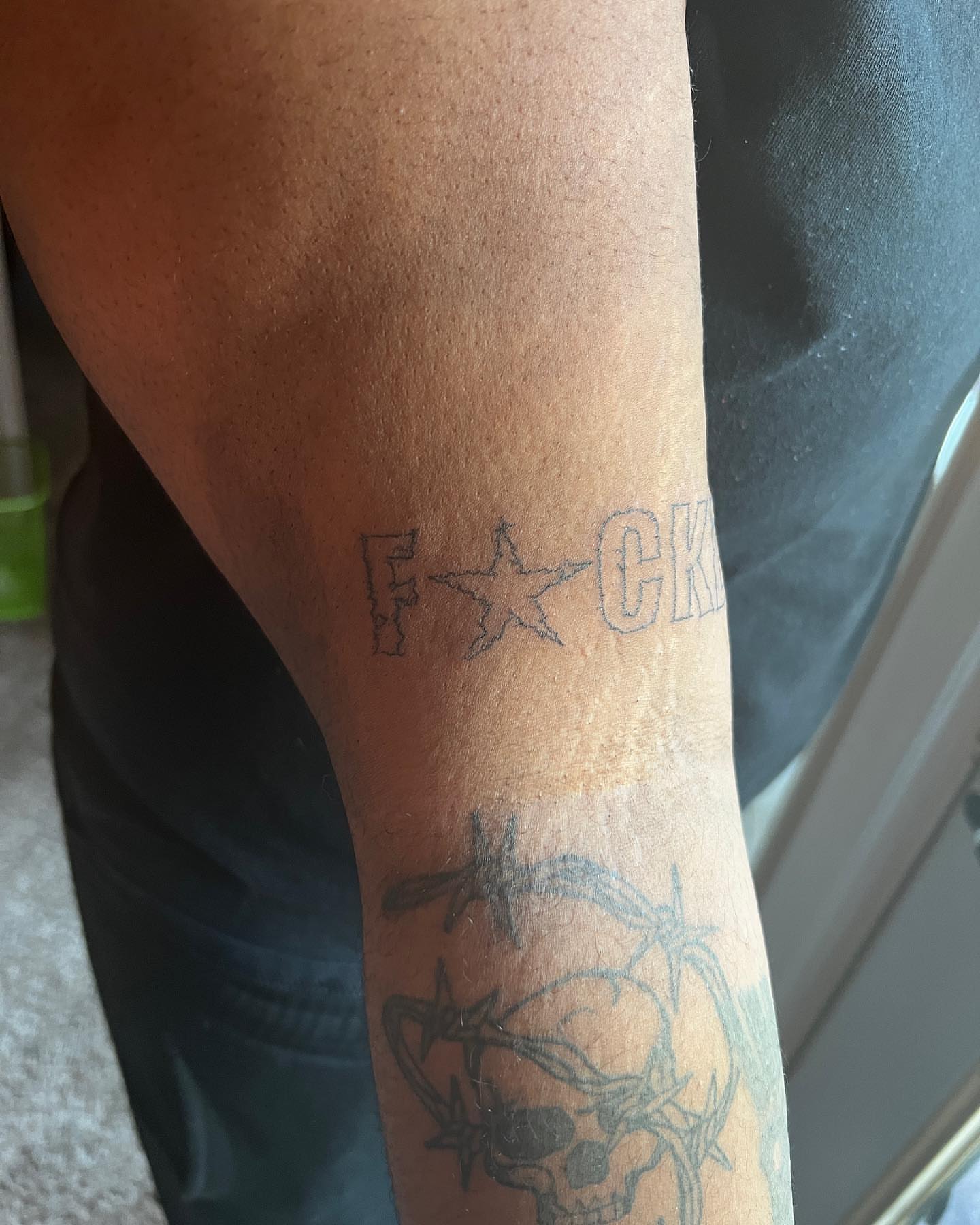 Star and lettering black and grey tattoo on the forearm by mars