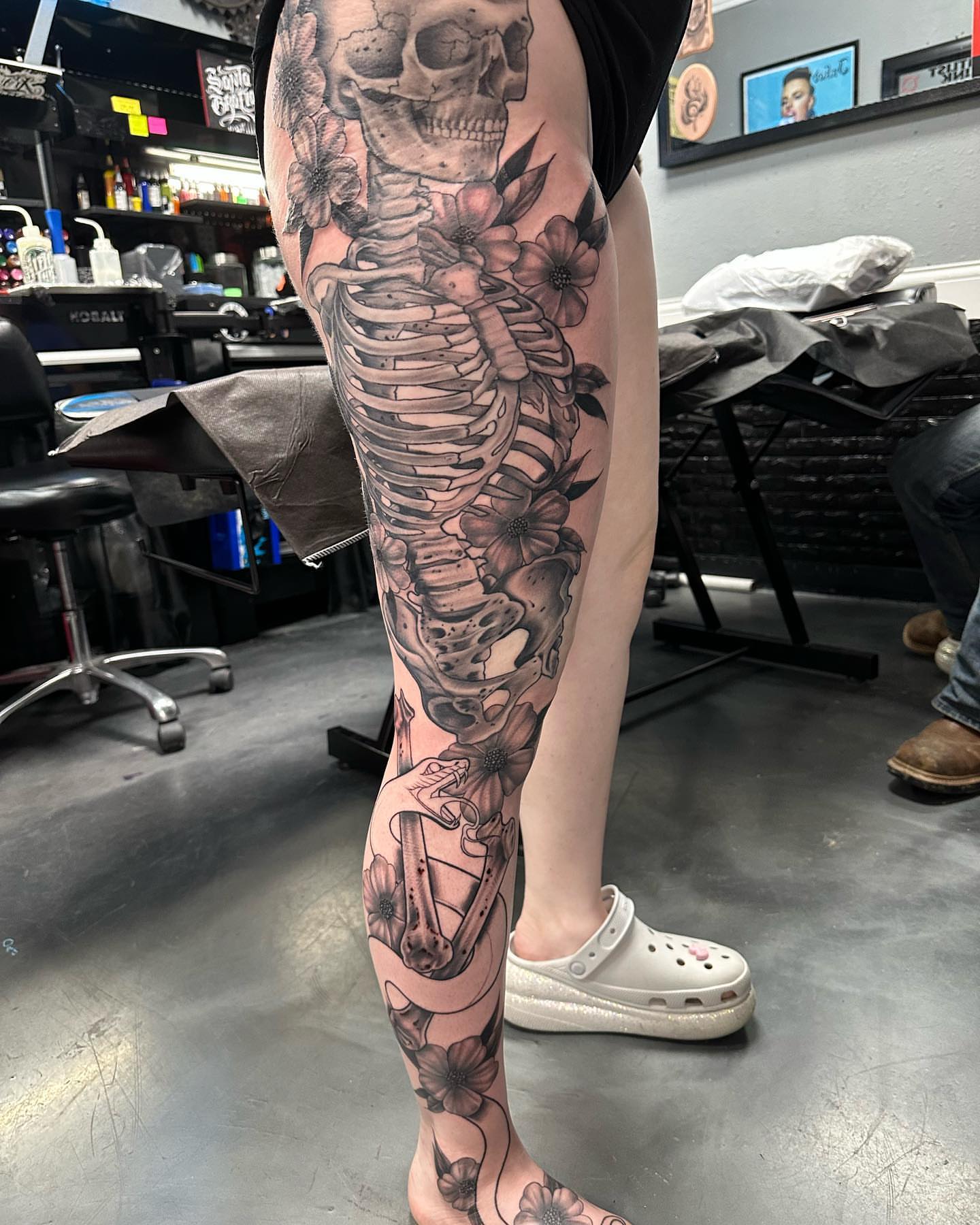 Skeleton with flowers realism tattoo on the calf by Pablo Venegas