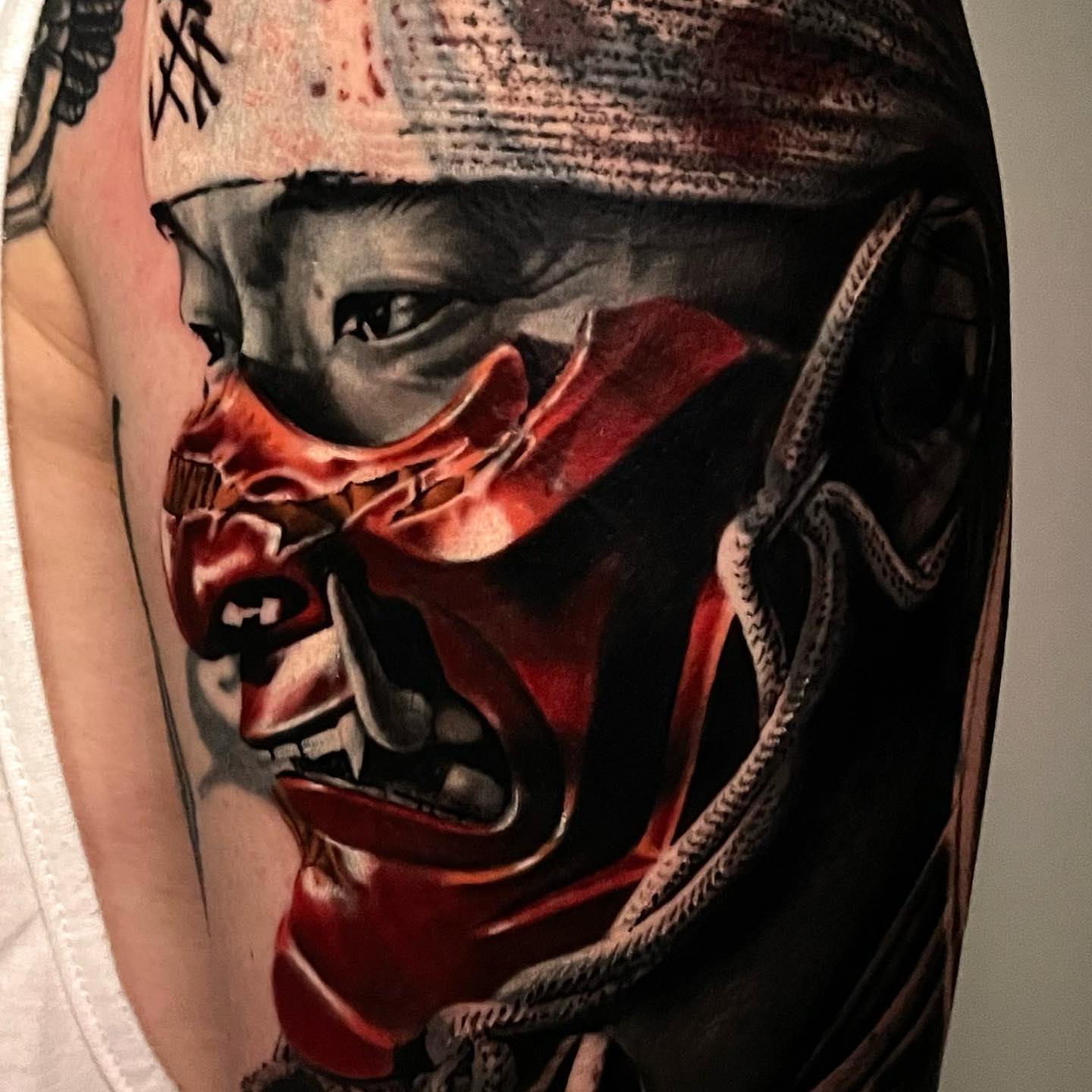 Demon mask dark realism tattoo on the forearm by Sadier Alfonso
