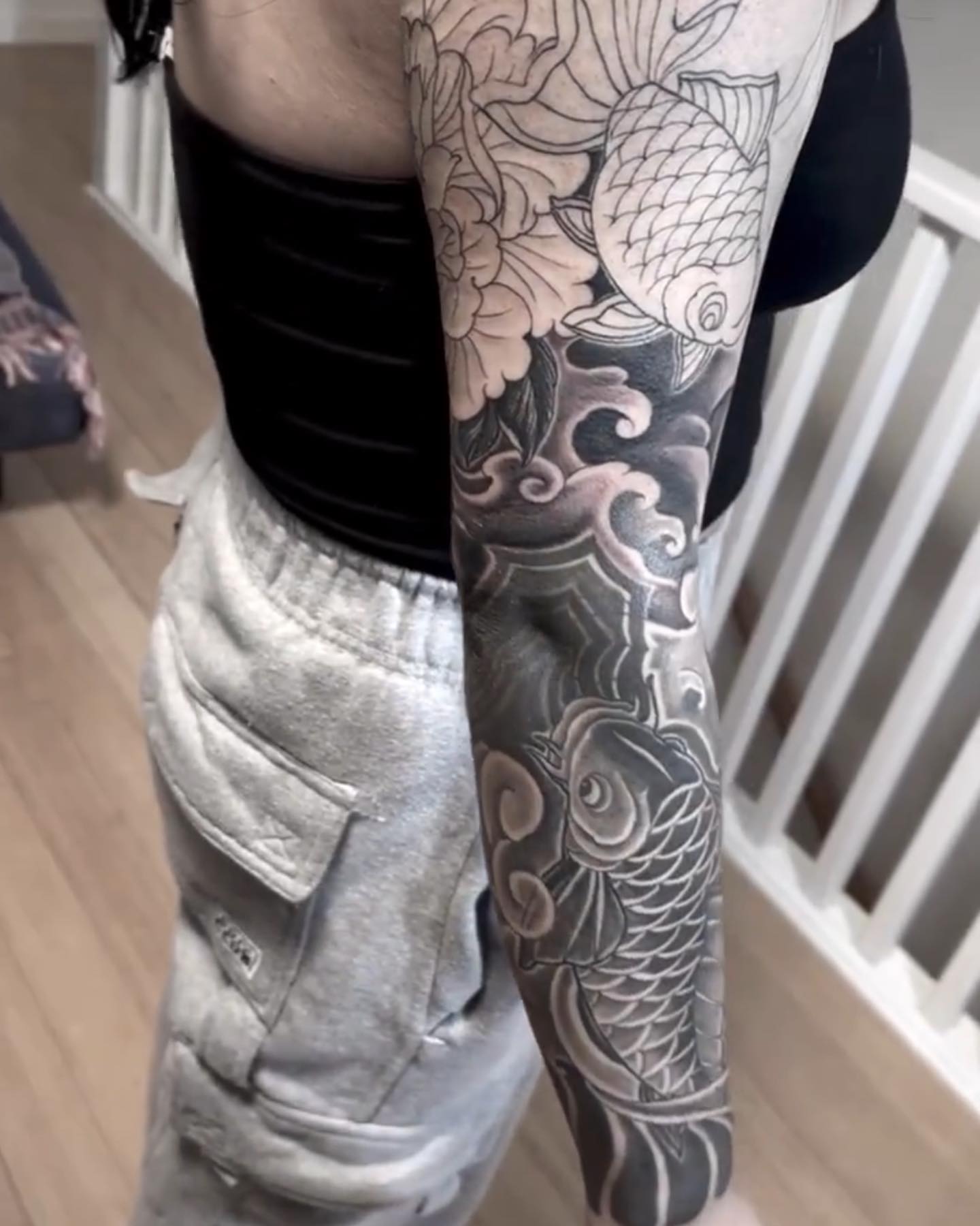 Koi fish and floral japanese irezumi tattoo on the forearm by Daniel Gutierrez