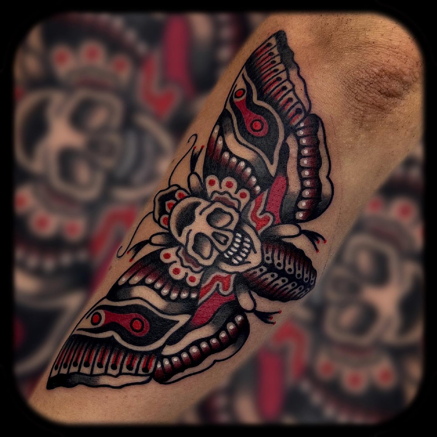 Skull and butterfly Chicano tattoo on the forearm by Benjamin Ward