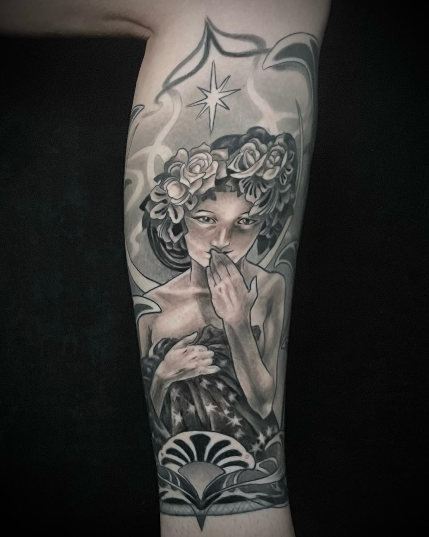 Woman with floral crown realism tattoo on the forearm by Laura Babsie