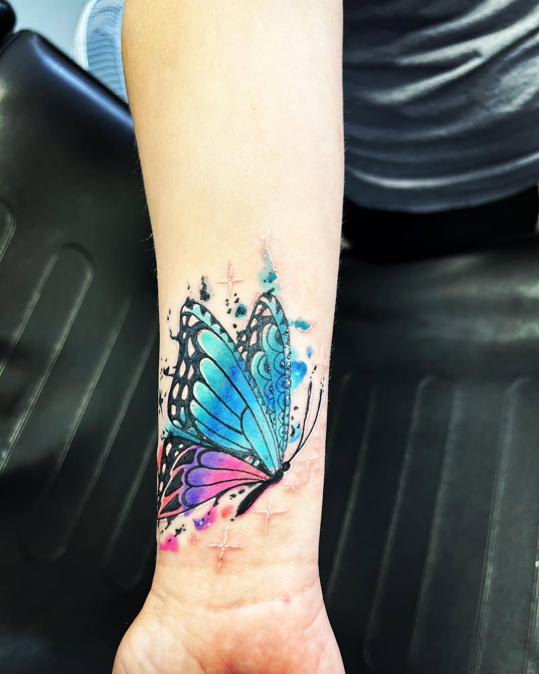 Butterfly watercolor tattoo on the forearm by Sk Pierce