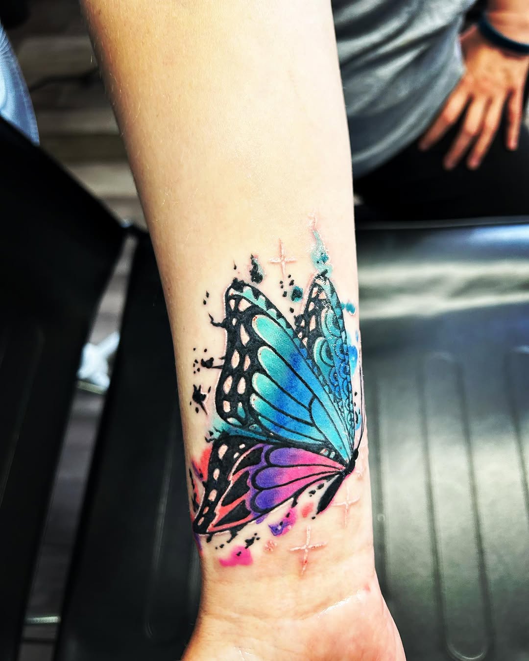 Butterfly watercolor tattoo on the forearm by Sk Pierce