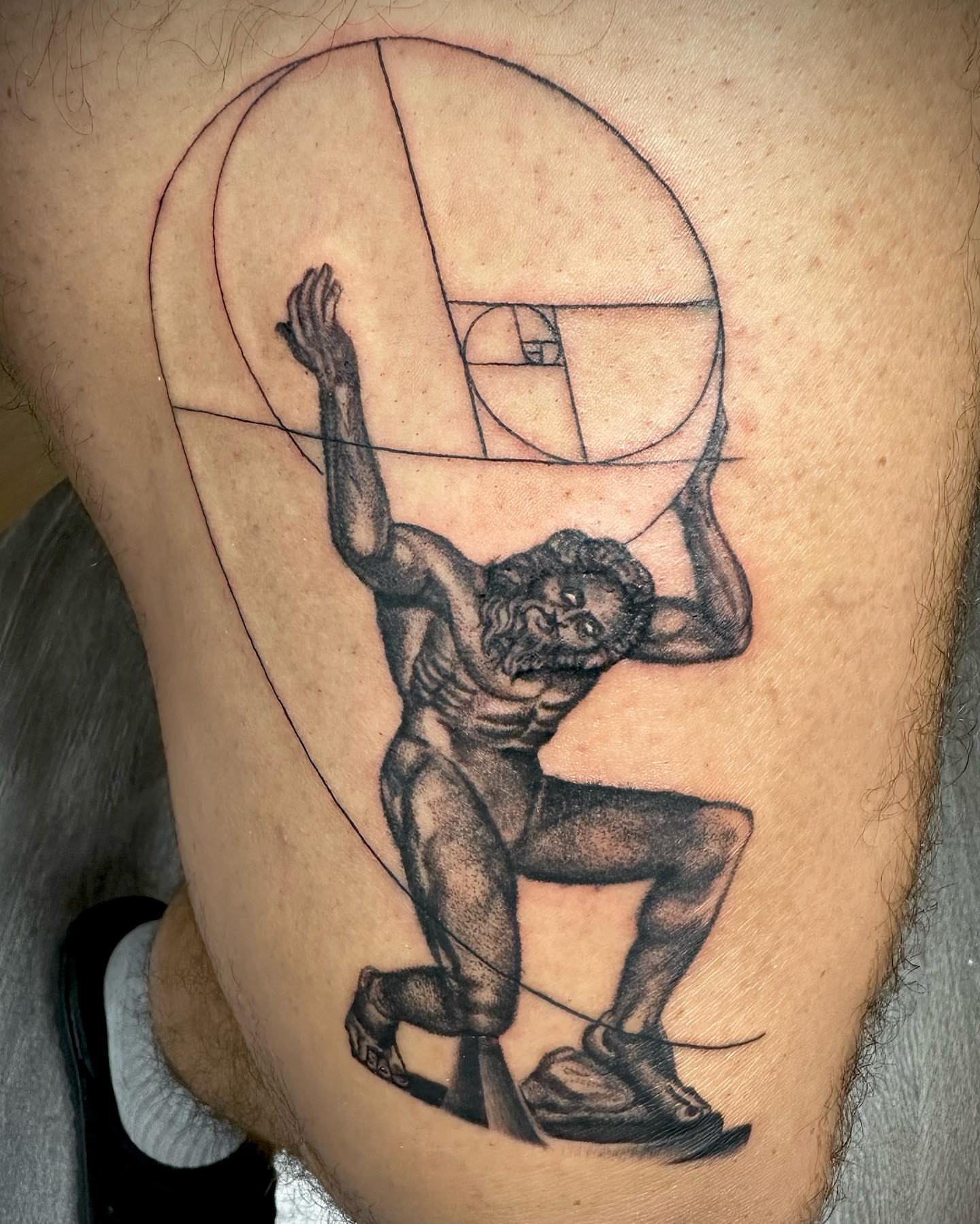 Man lifting sphere geometric tattoo on the thigh by MR