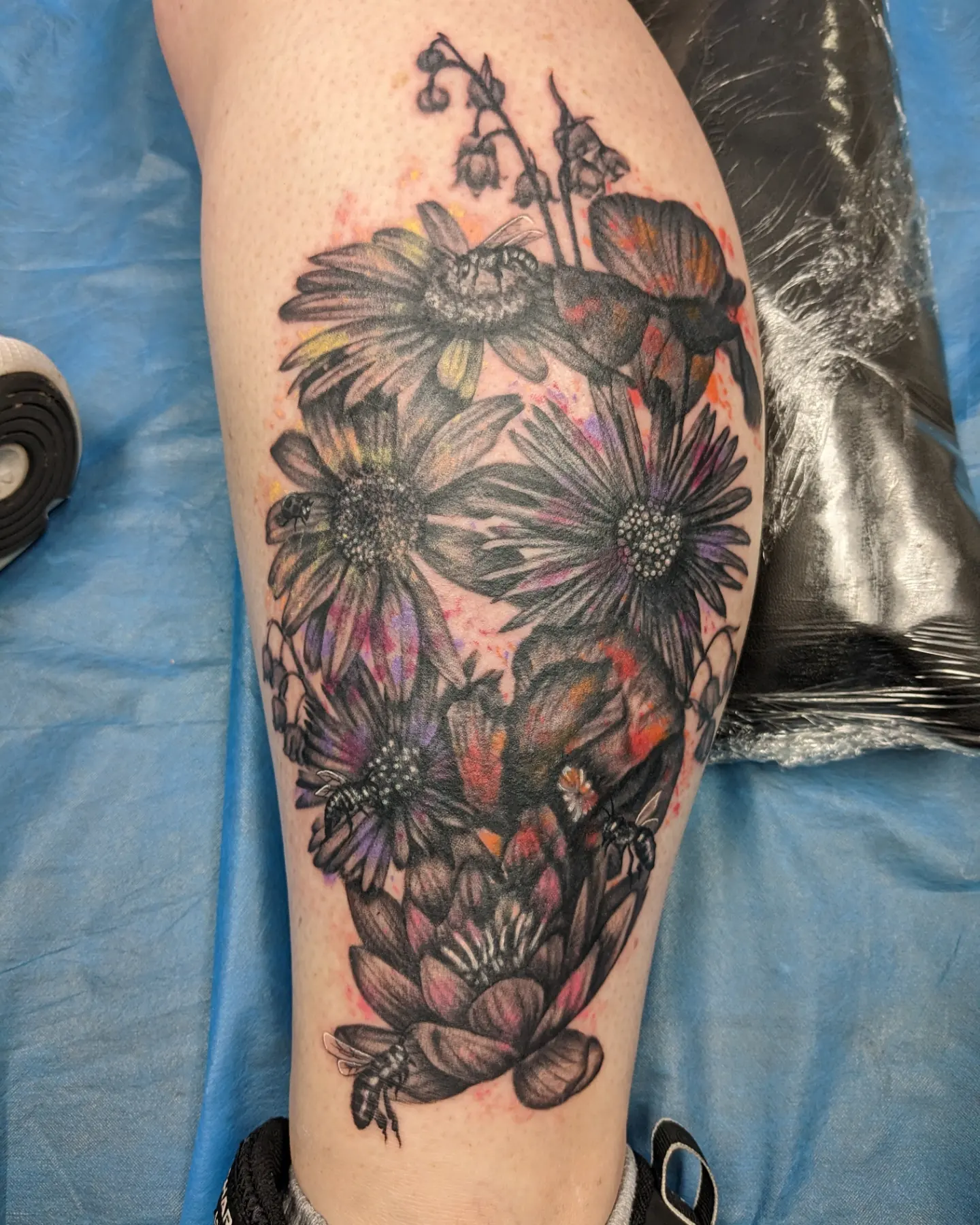 Daisies and bees watercolor tattoo on the thigh by Kara Falcon