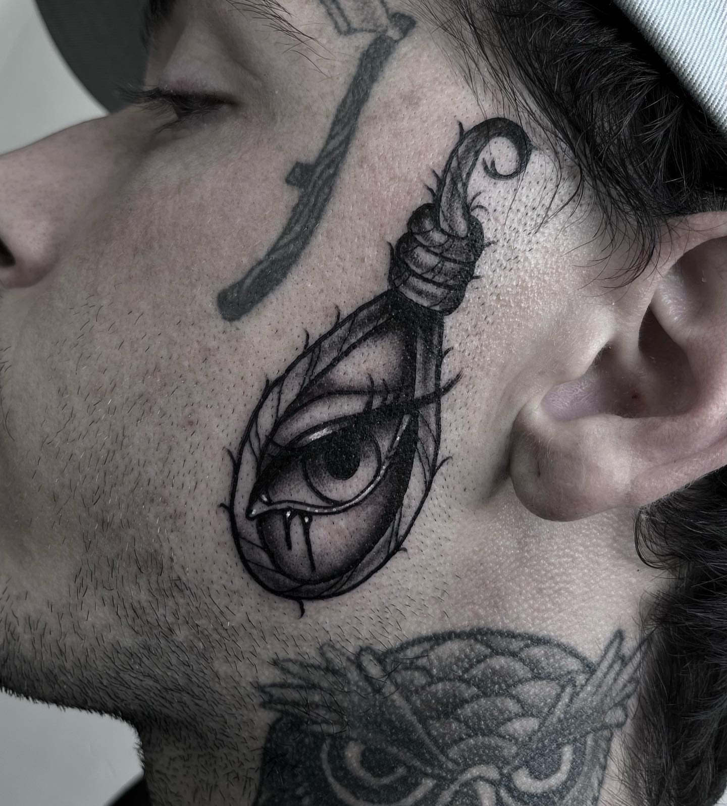 Eye with snake realism tattoo on the neck by Sofia Rose