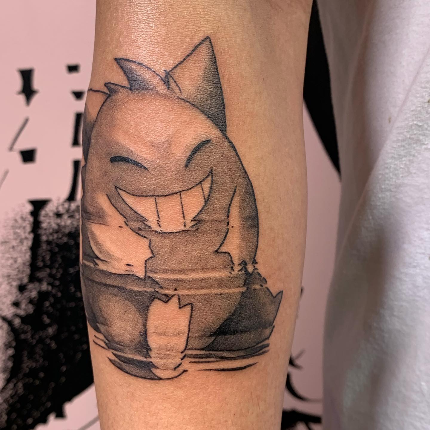 Gengar black and grey tattoo on the forearm by Sarah