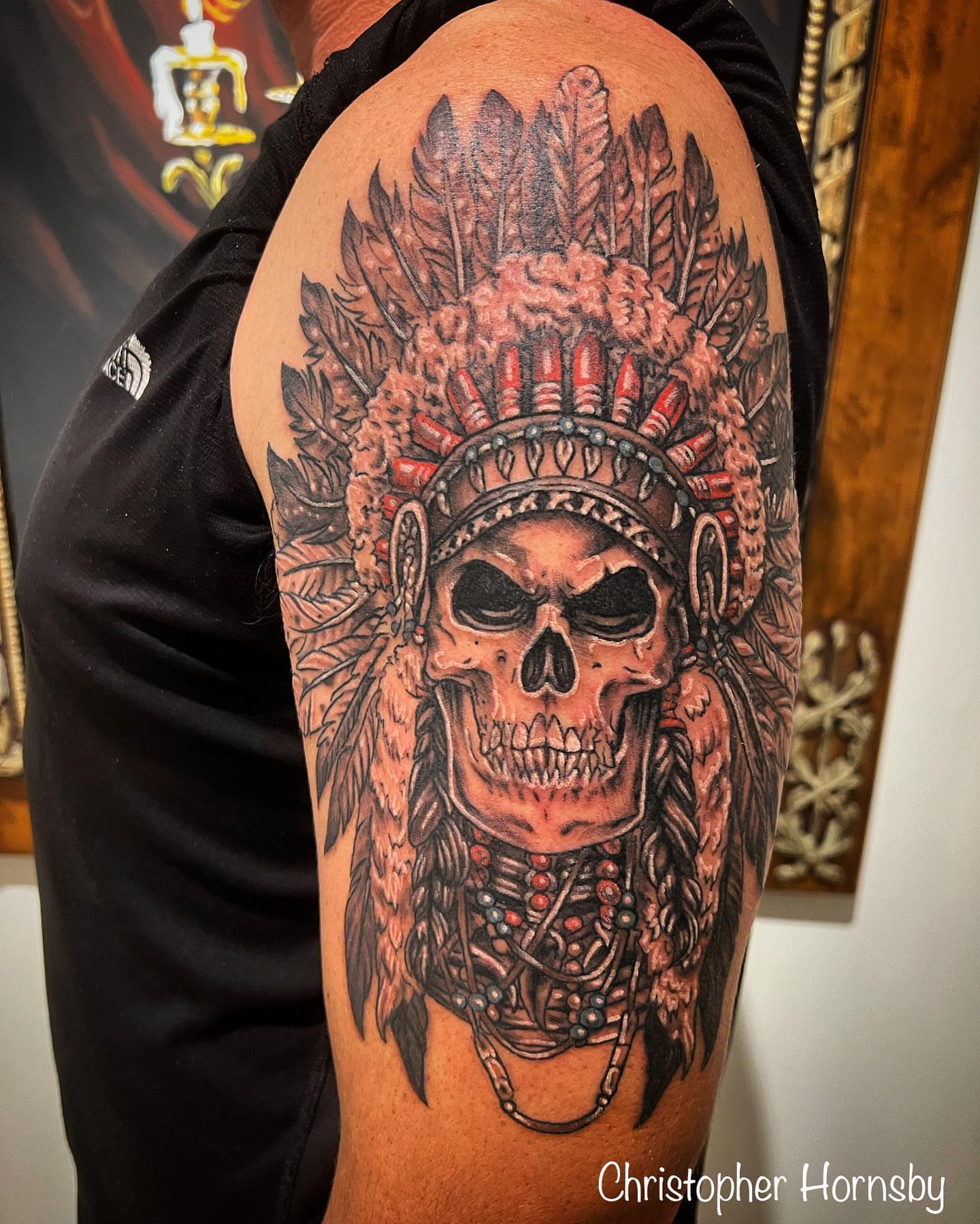 Skull with headdress realism tattoo on the shoulder by Chris Hornsby