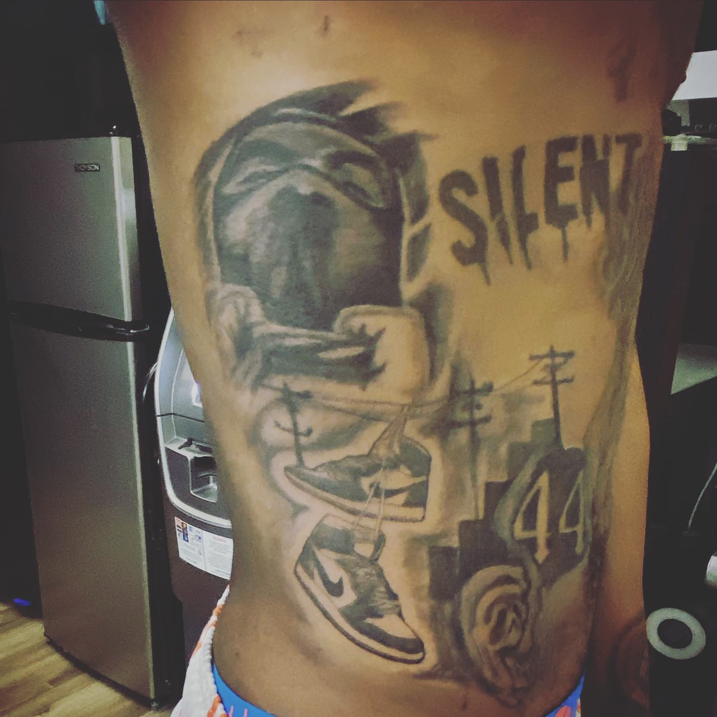 Street art realism tattoo on the torso by Erasmo Vasquez