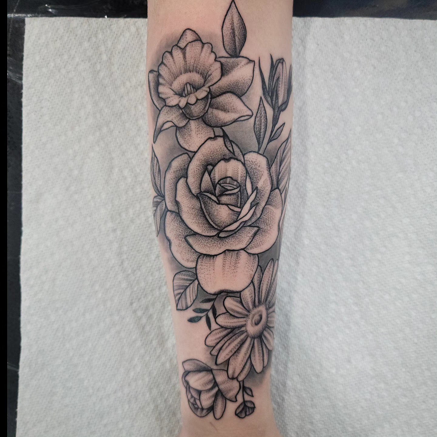 Floral arrangement dotwork tattoo on the forearm by Dick Eckman