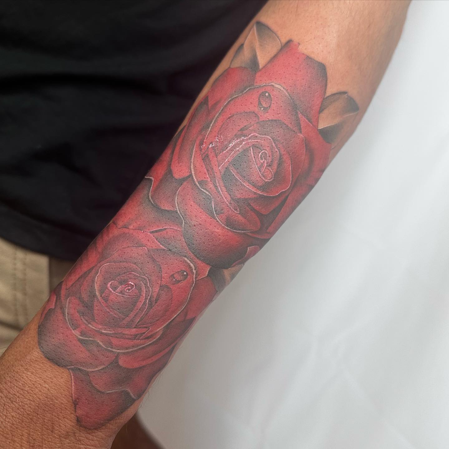 Red roses realism tattoo on the forearm by Rachel Martinez