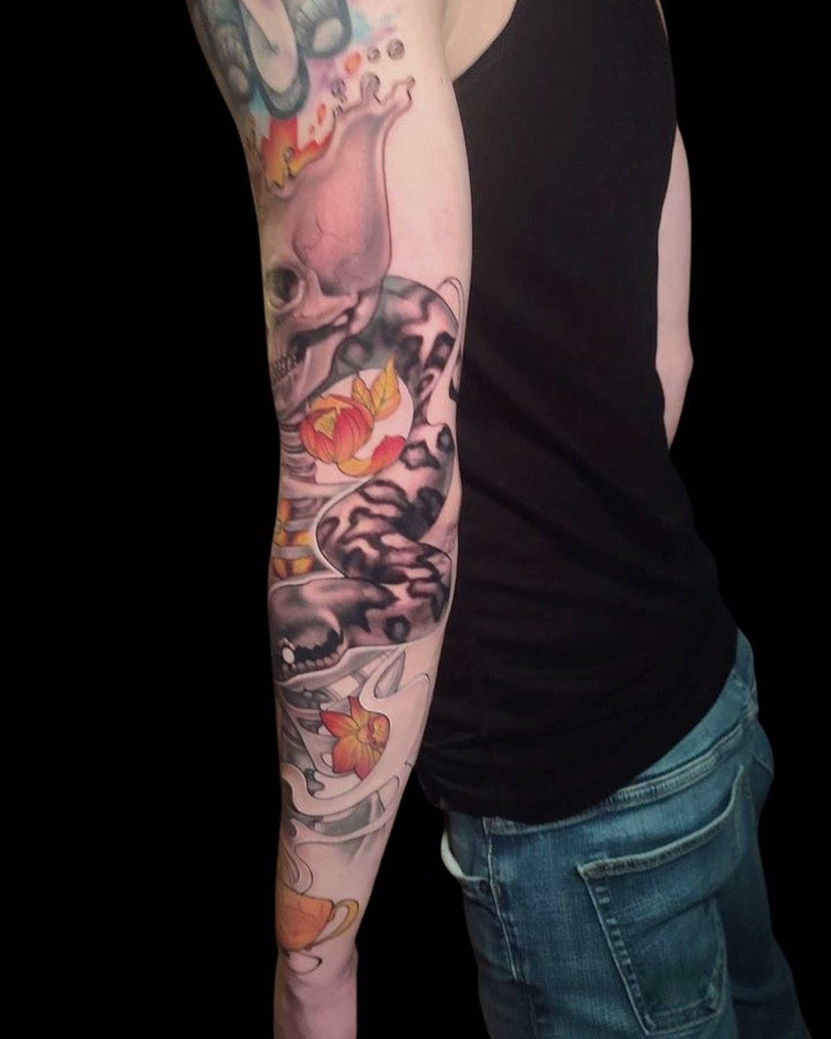 Skull and lotus American traditional tattoo on the forearm by Rain Delmar