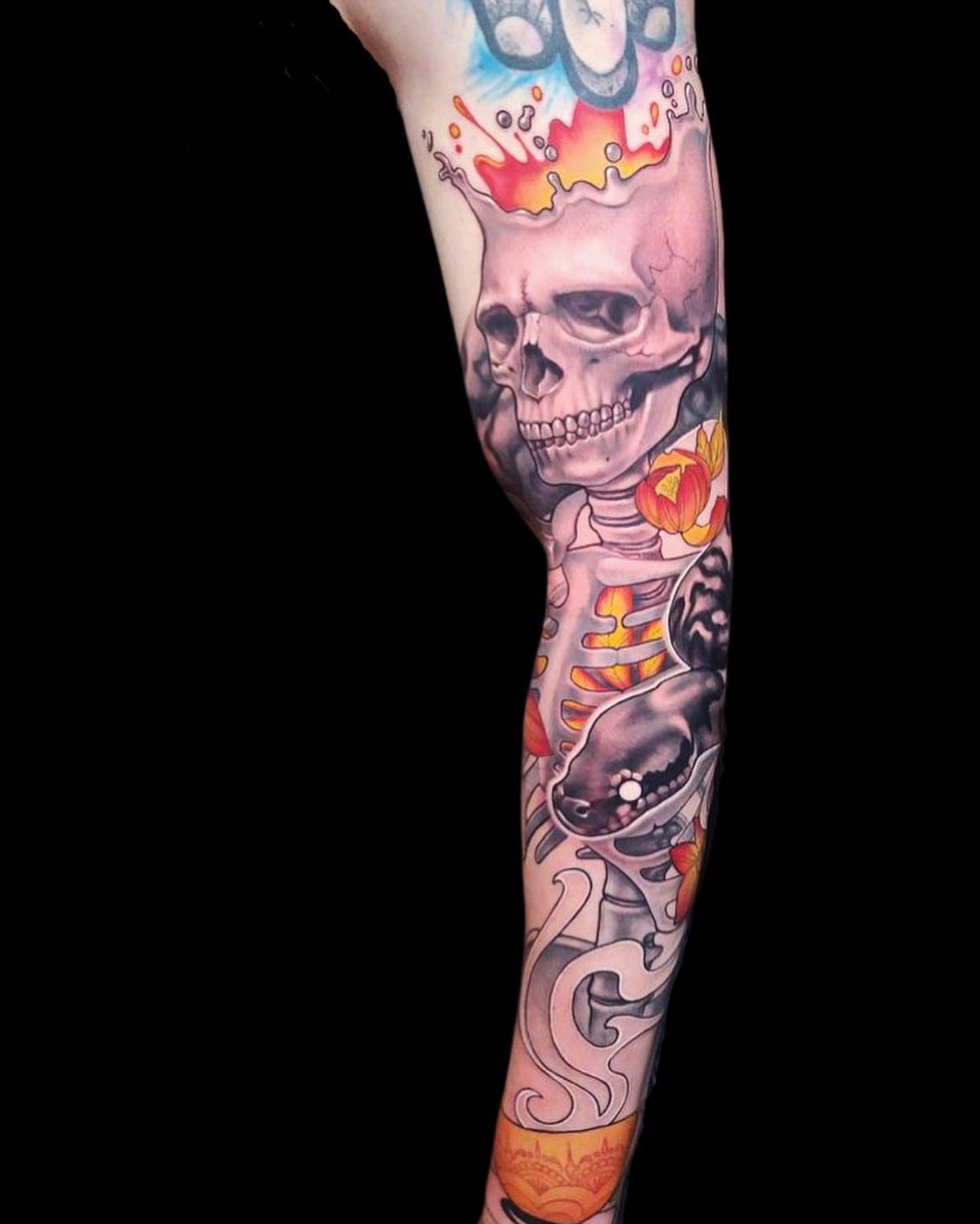 Skull and flames American traditional tattoo on the forearm by Rain Delmar