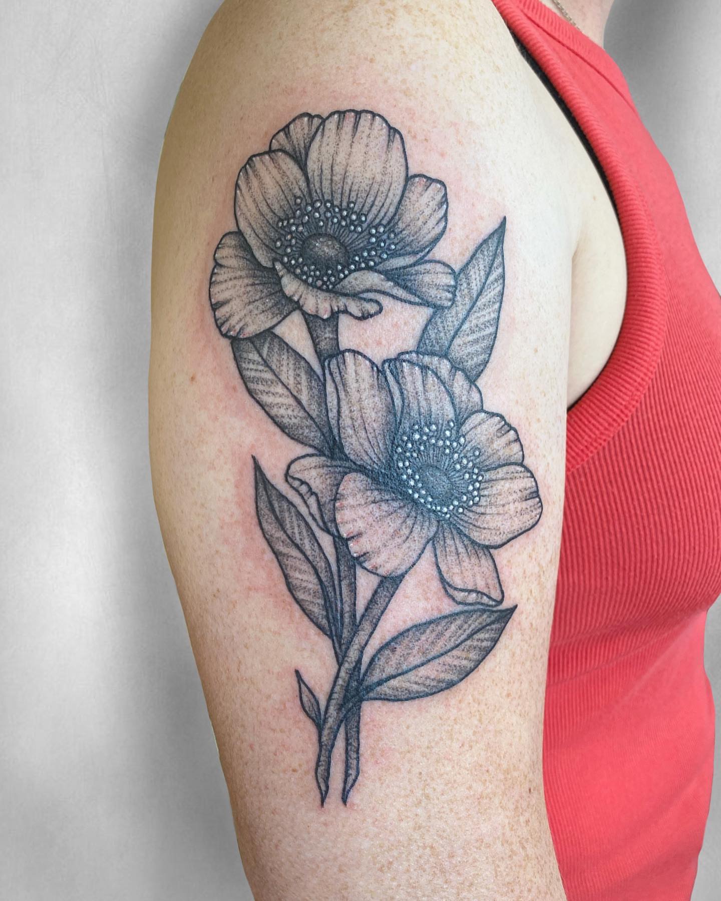 Flowers dotwork tattoo on the upper arm by Mallory Miller π³οΈβπ Eugene