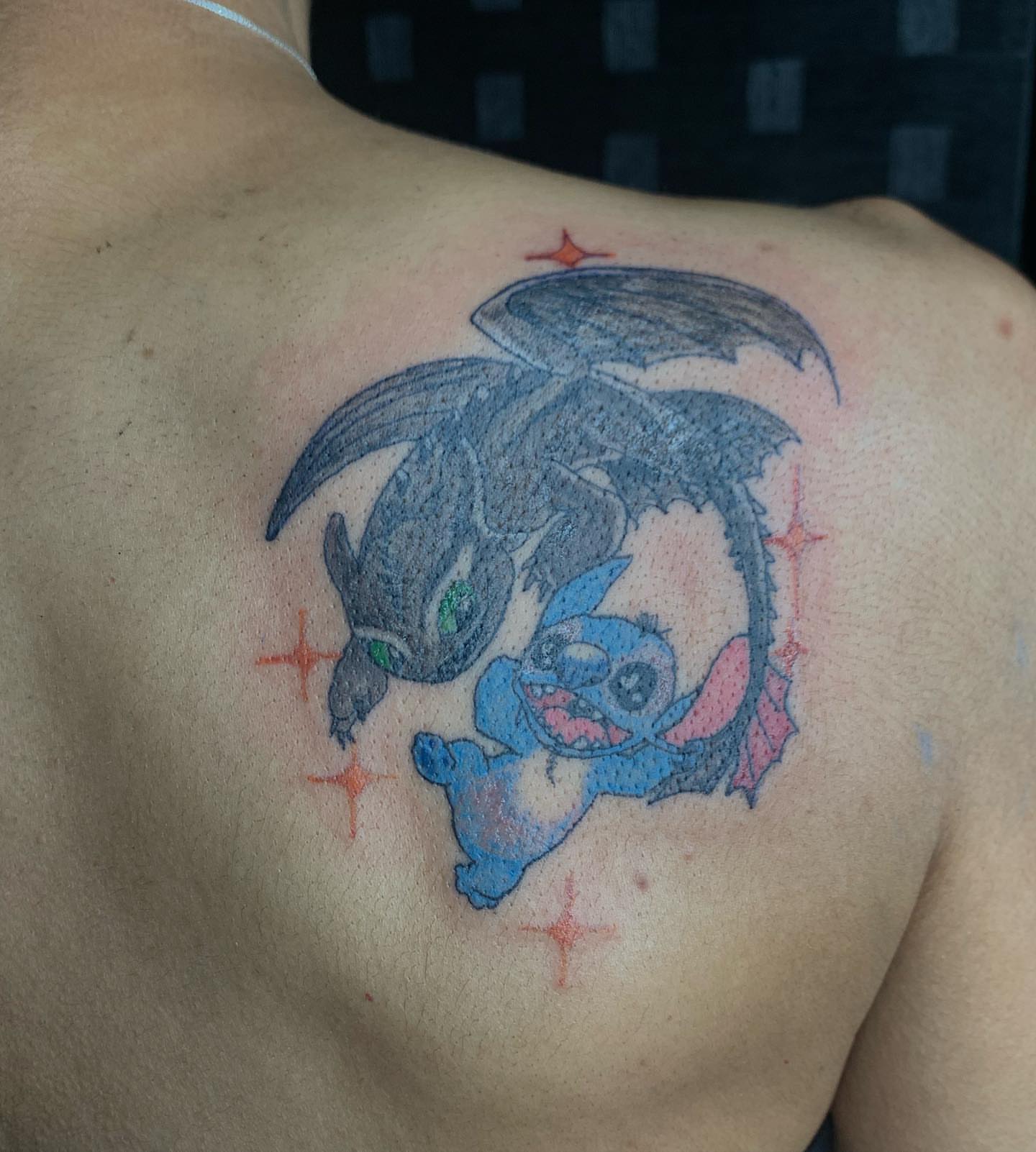 Dragon and stitch dotwork tattoo on the back by Evan Chastain