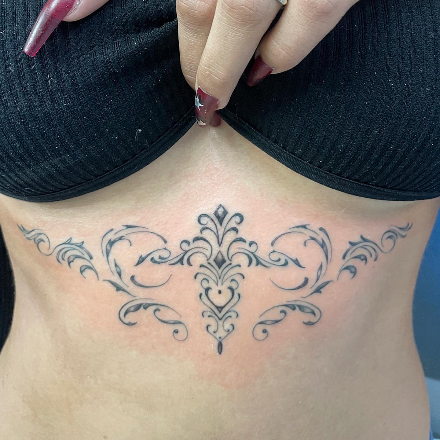 Floral ornament ornamental tattoo on the torso by Manny