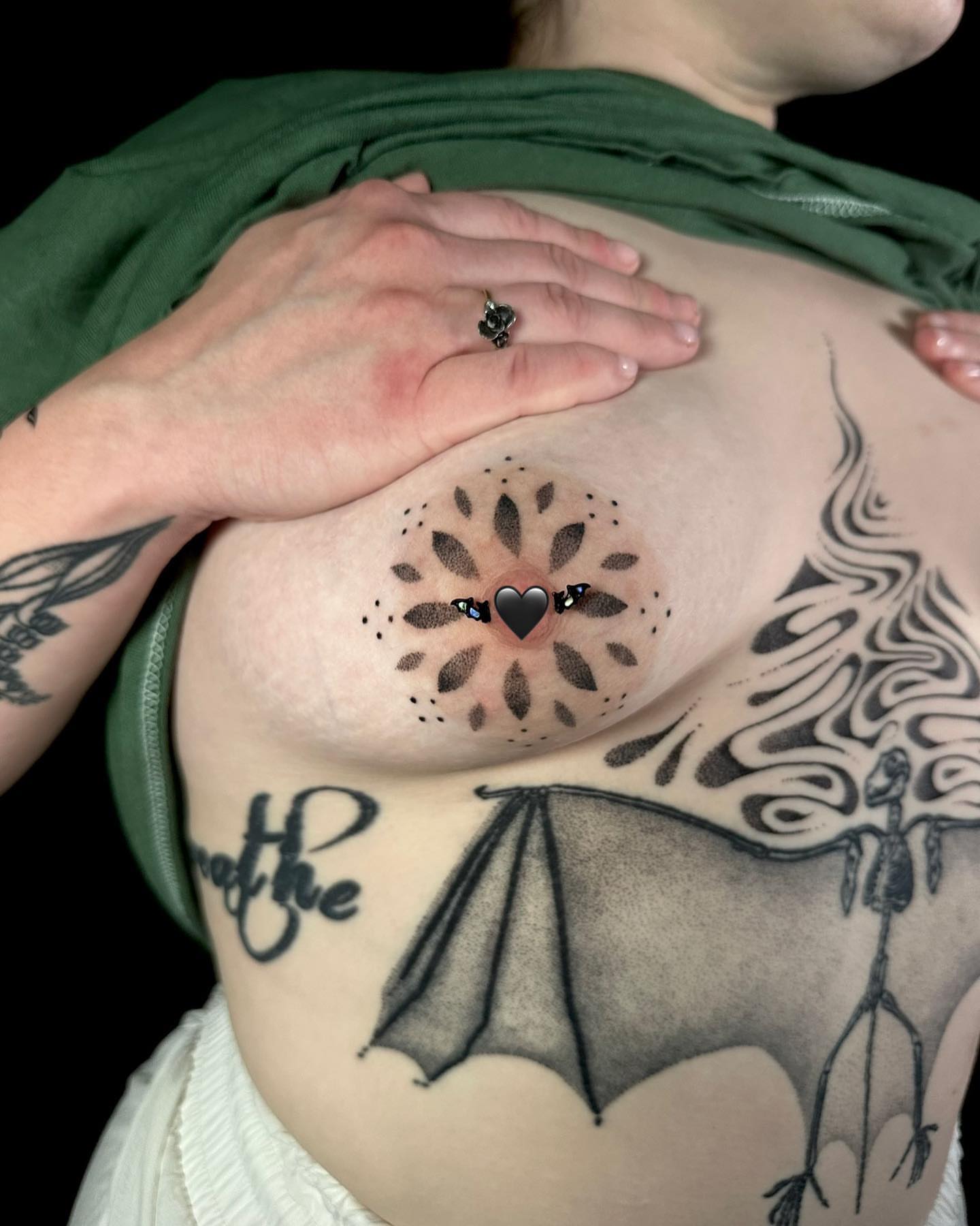 Heart with floral mandala dotwork tattoo on the chest by Chelsey