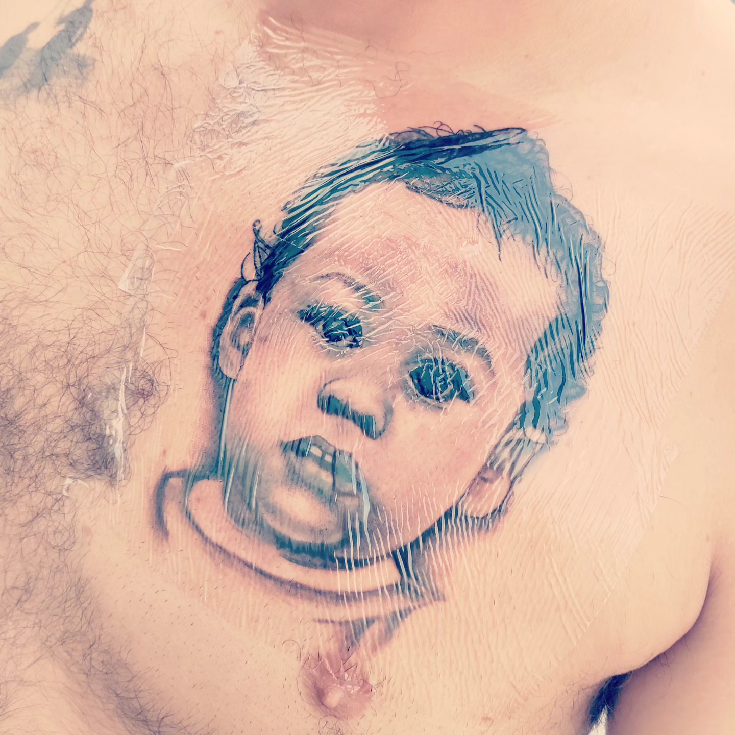 Clown face realism tattoo on the chest by Noriega Josué