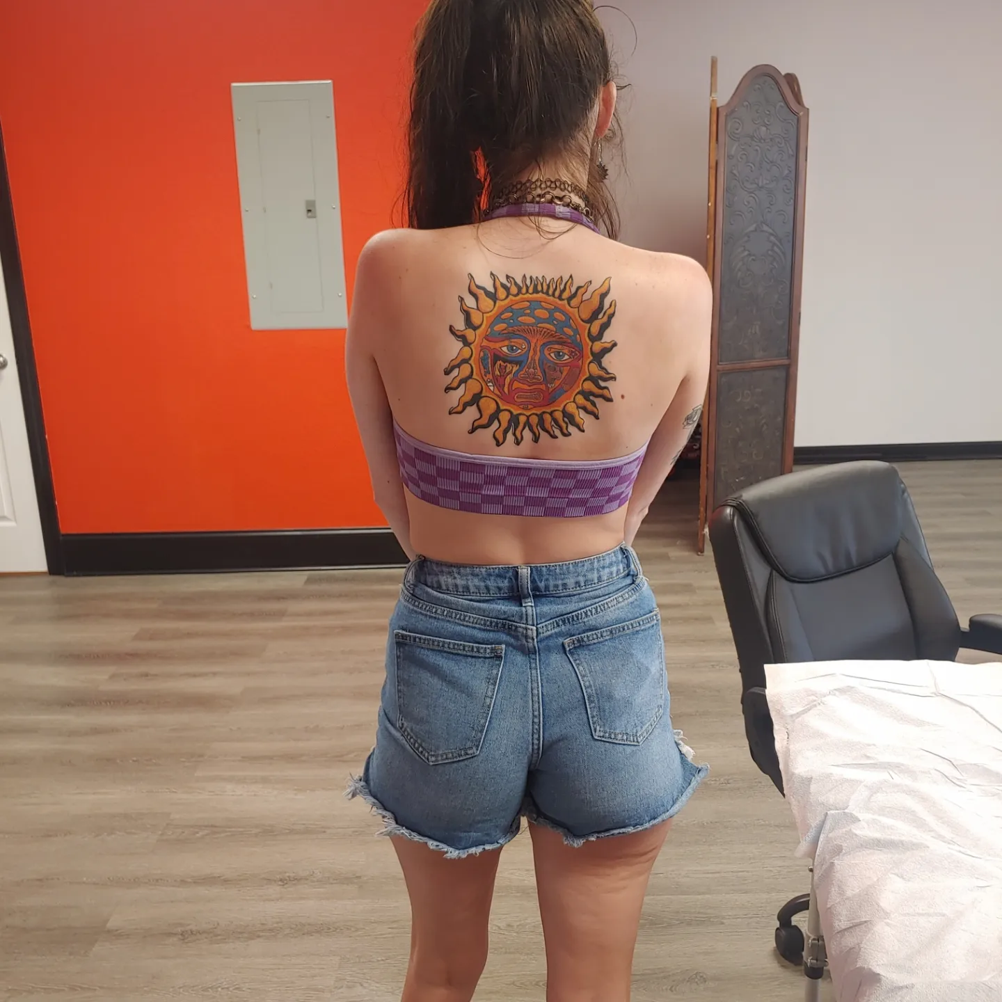 Sun face American traditional tattoo on the back by Gene Britton