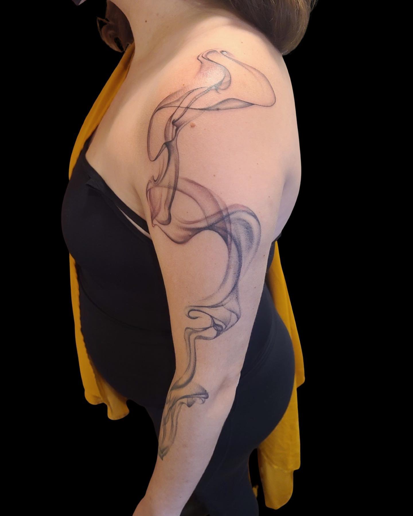 Smoke black and grey tattoo on the shoulder by Rain Delmar