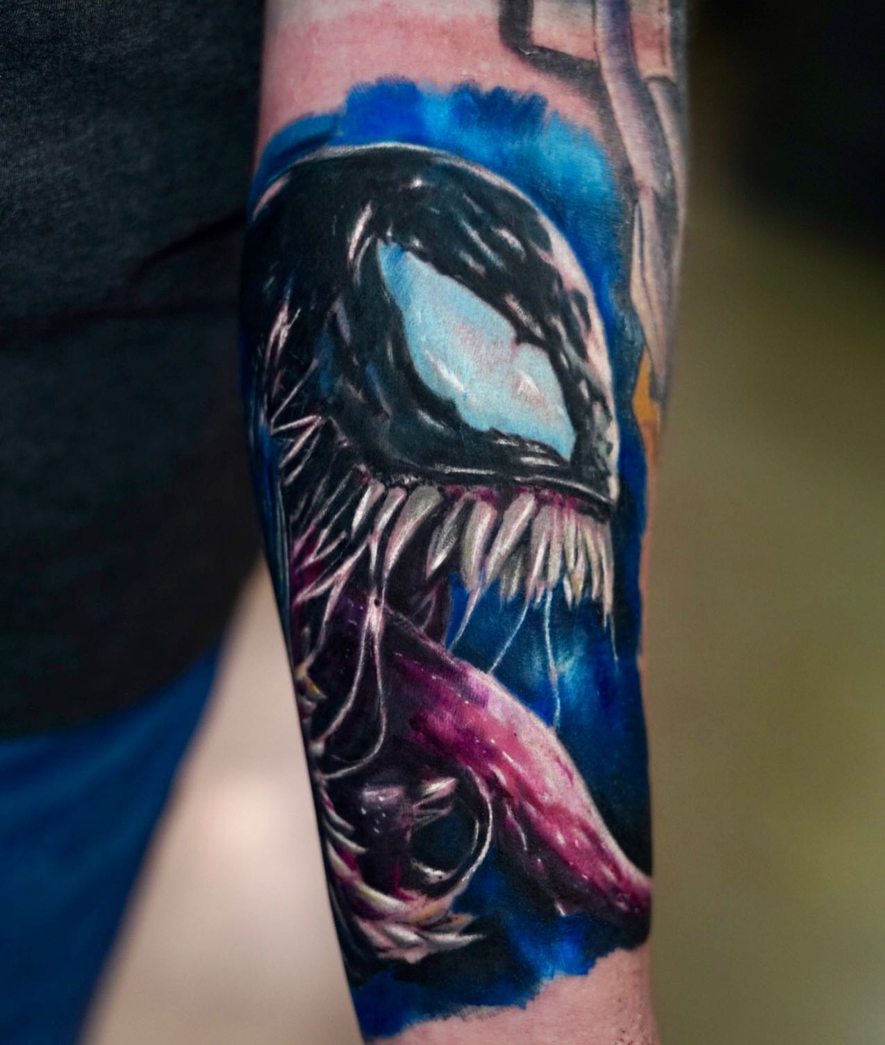 Venom realism tattoo on the forearm by Sly Davis