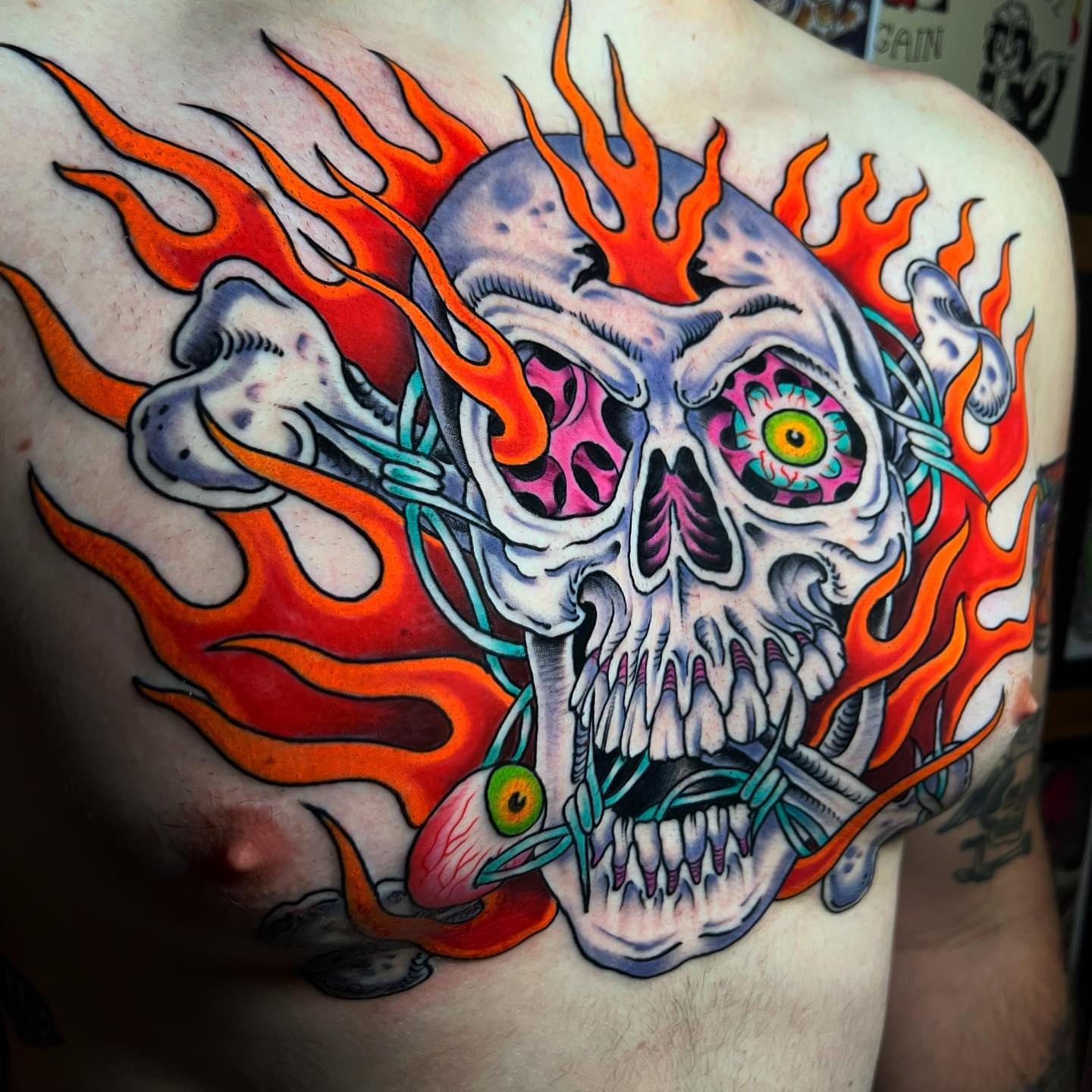 Flaming skull American traditional tattoo on the shoulder by Barron